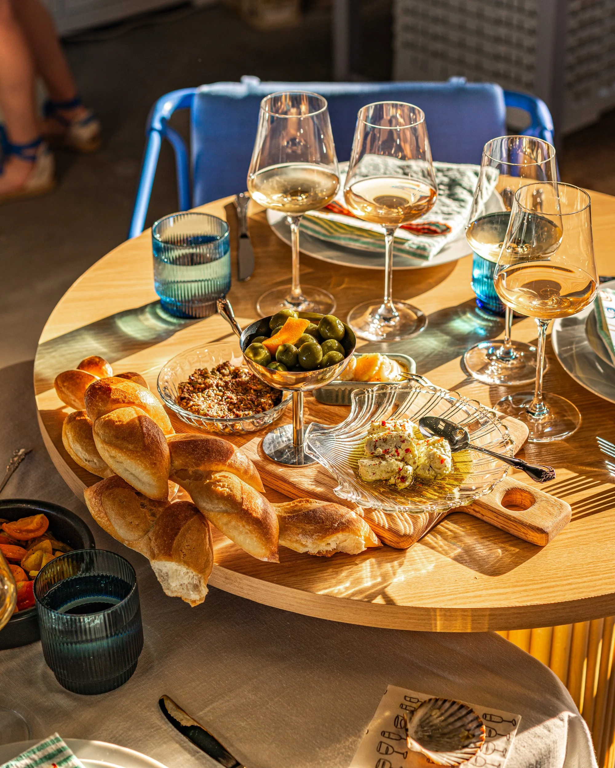 A table set for wine and dinner during a Stoop Supper Club event at The River Club Napa.