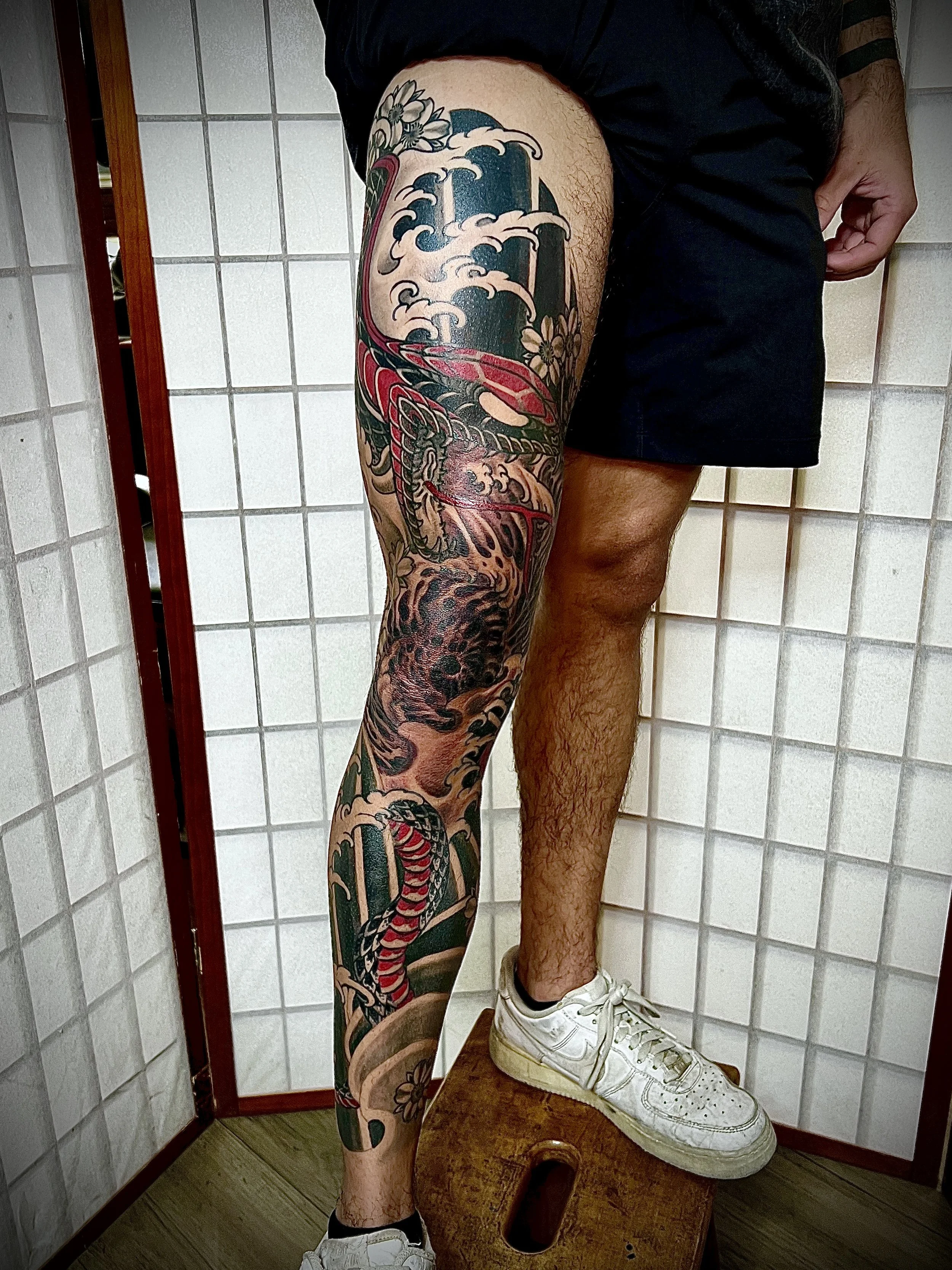 Snake water and cherry blossoms tattoo