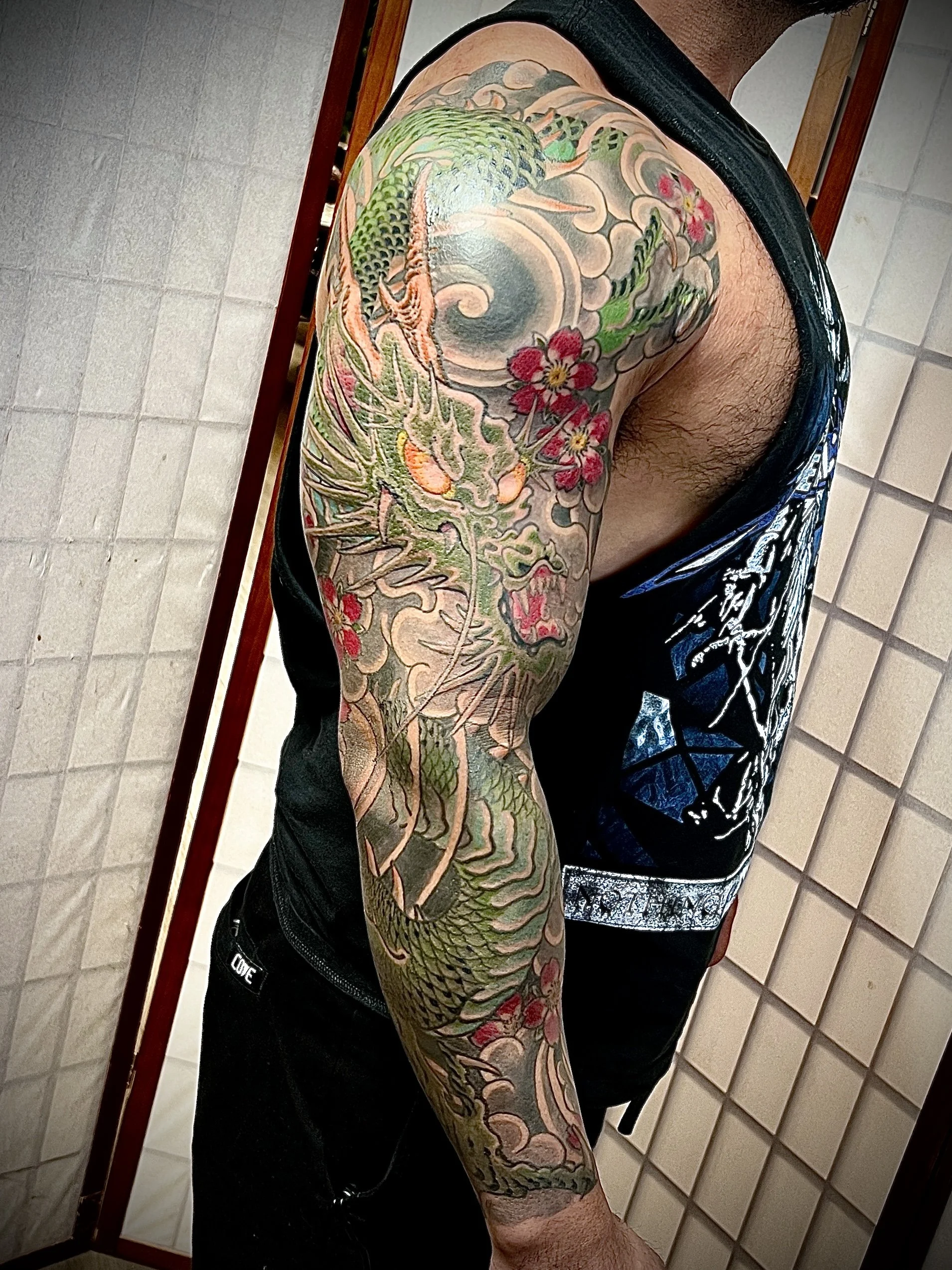 Dragon wind and cherry blossoms tattoo sleeve