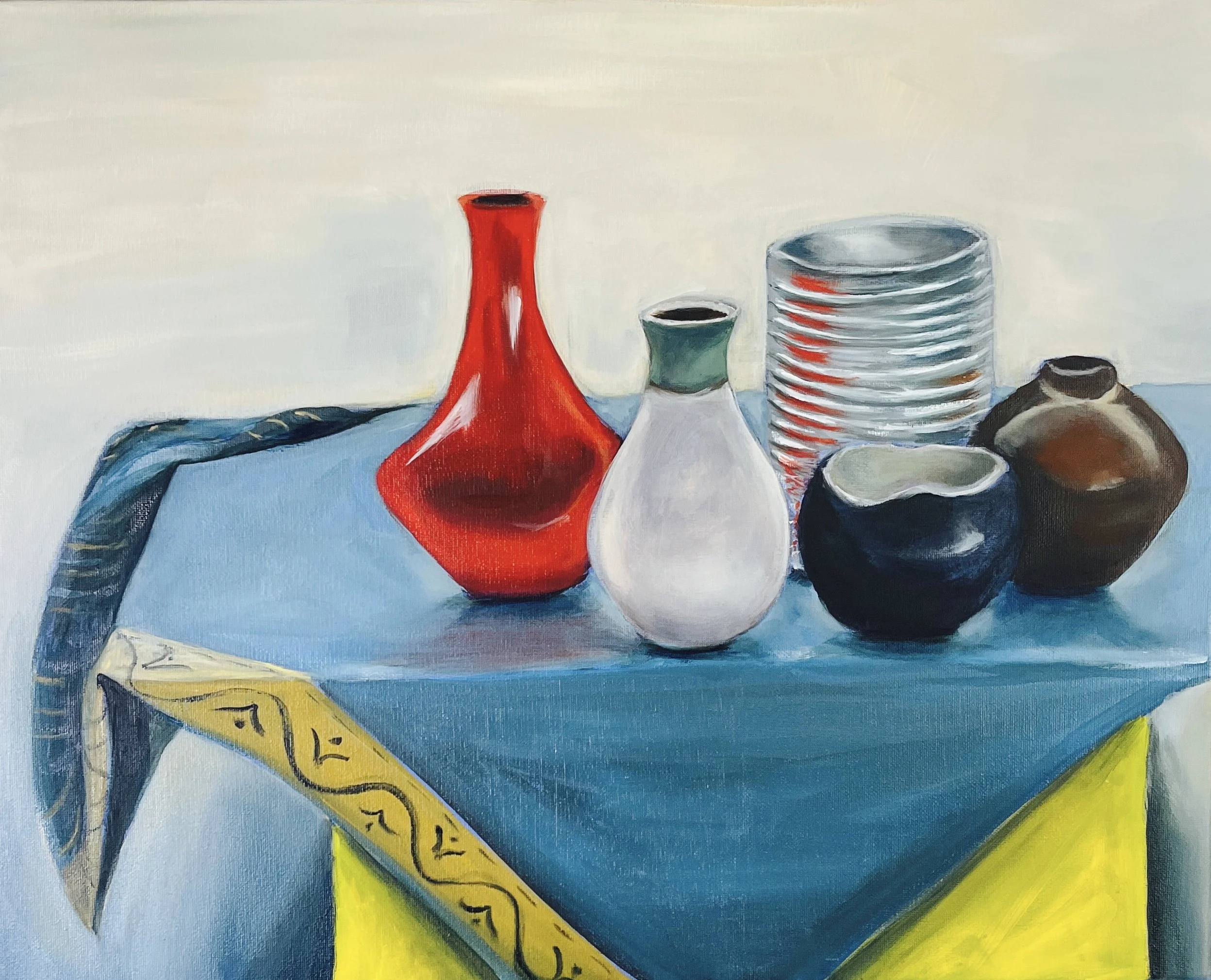 A still life painting of various ceramic and glass vases and bowls on a blue surface, with a blue cloth partially covering the table, and a yellow strip with black markings on the edge.