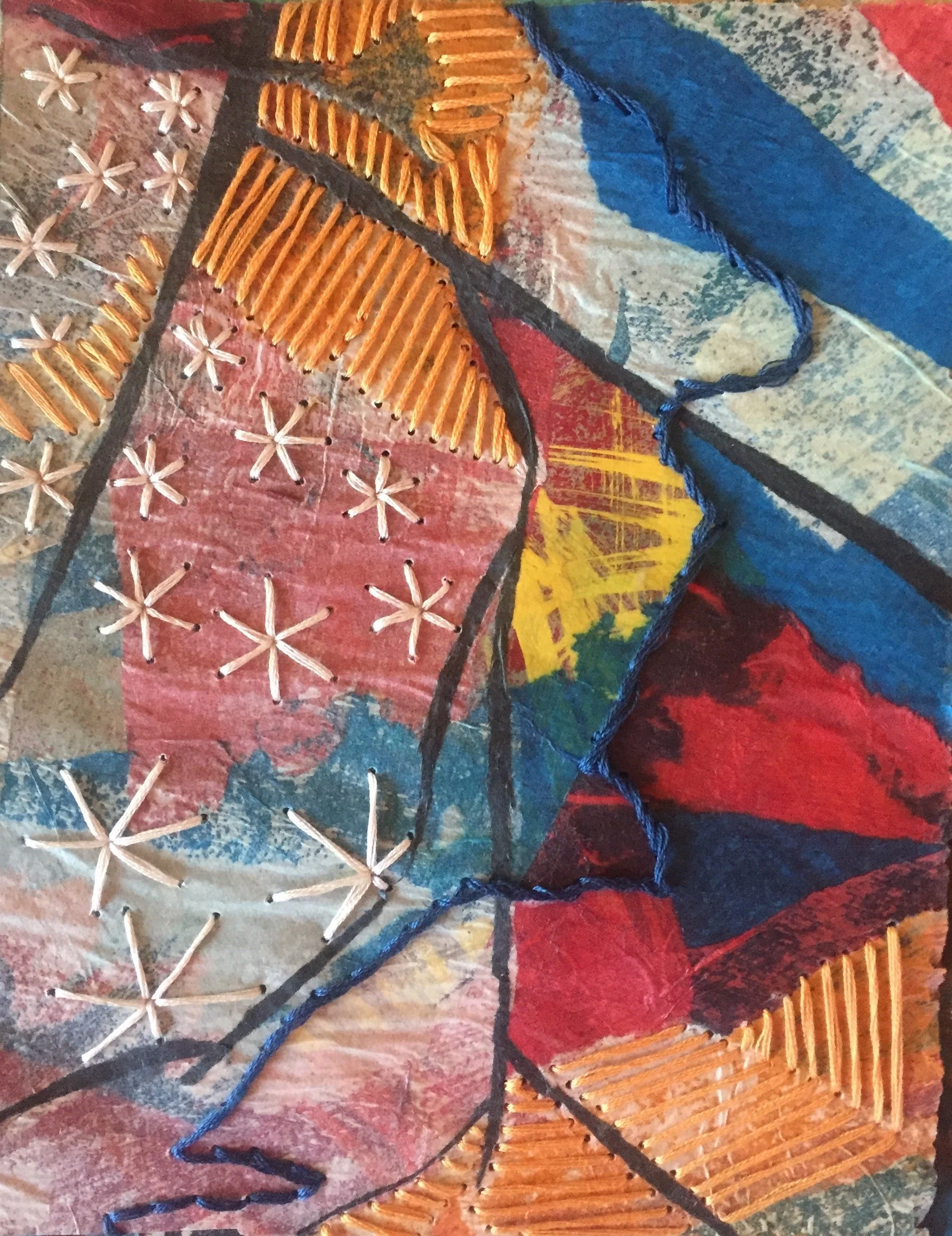 Art by Hilary Saner. Close-up of a colorful, abstract textile artwork with embroidered and stitched details, featuring various colors including red, blue, yellow, black, and beige.