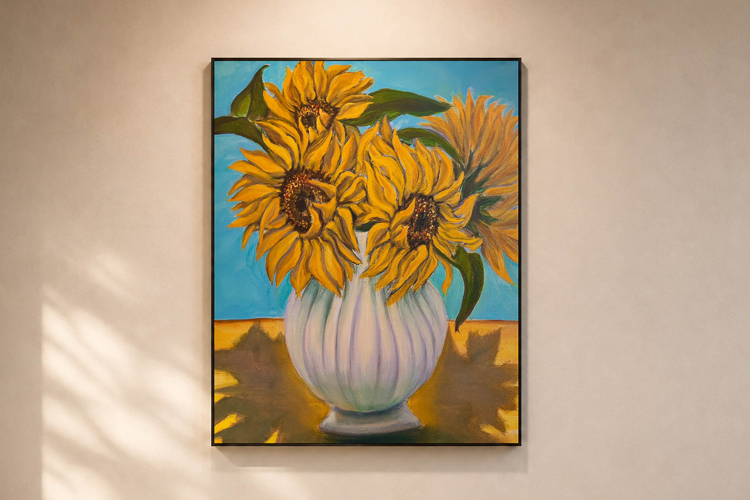 A colorful painting of a bouquet of sunflowers in a white vase, displayed on a beige wall.