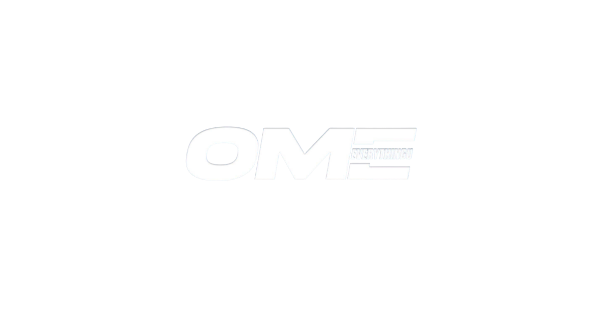 Black background with white text that says 'OM' in bold and larger font, with smaller text saying 'EVERYTHING' inside the letter 'E'.
