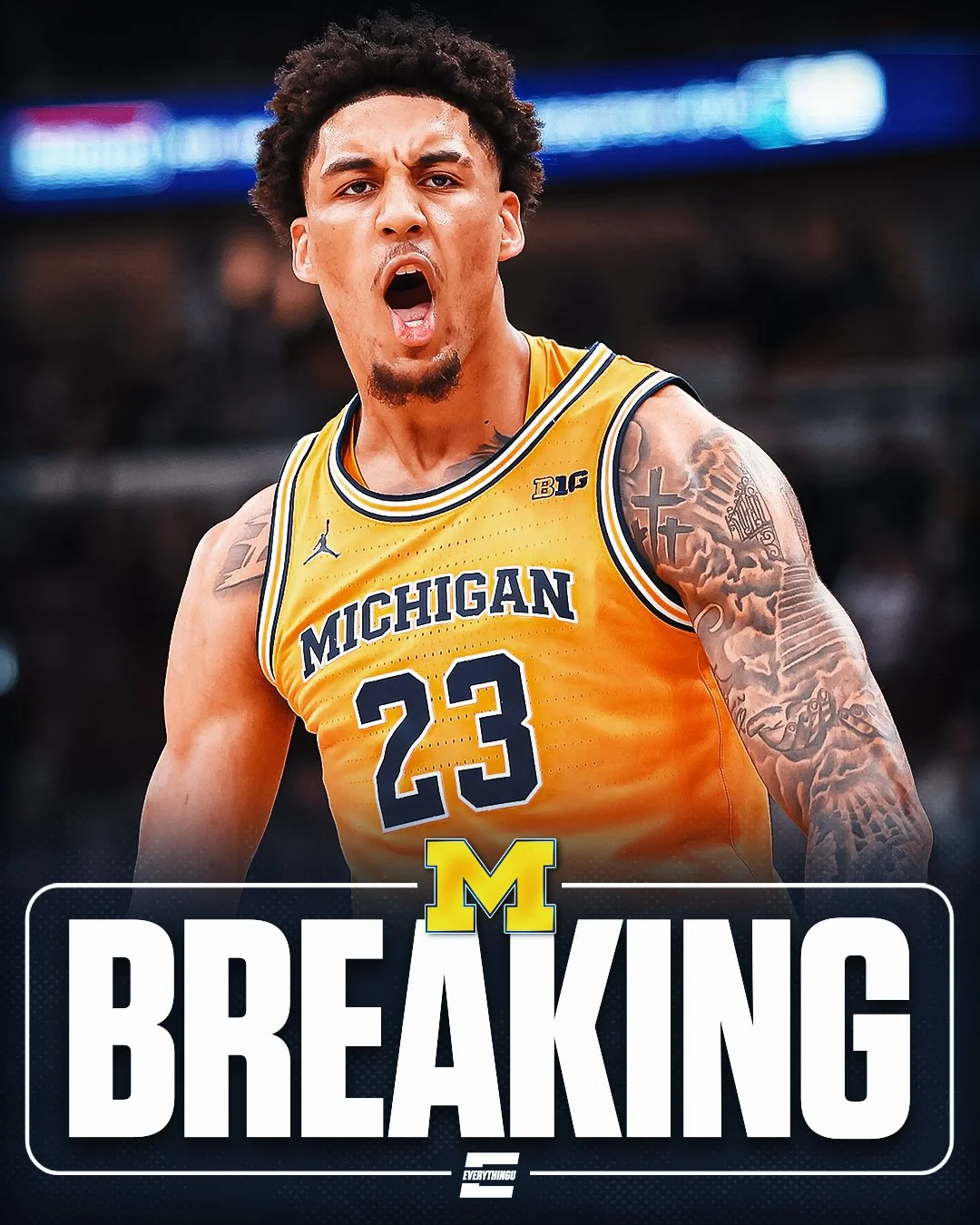 A basketball player wearing a Michigan jersey with the number 23, passionately celebrating on the court.