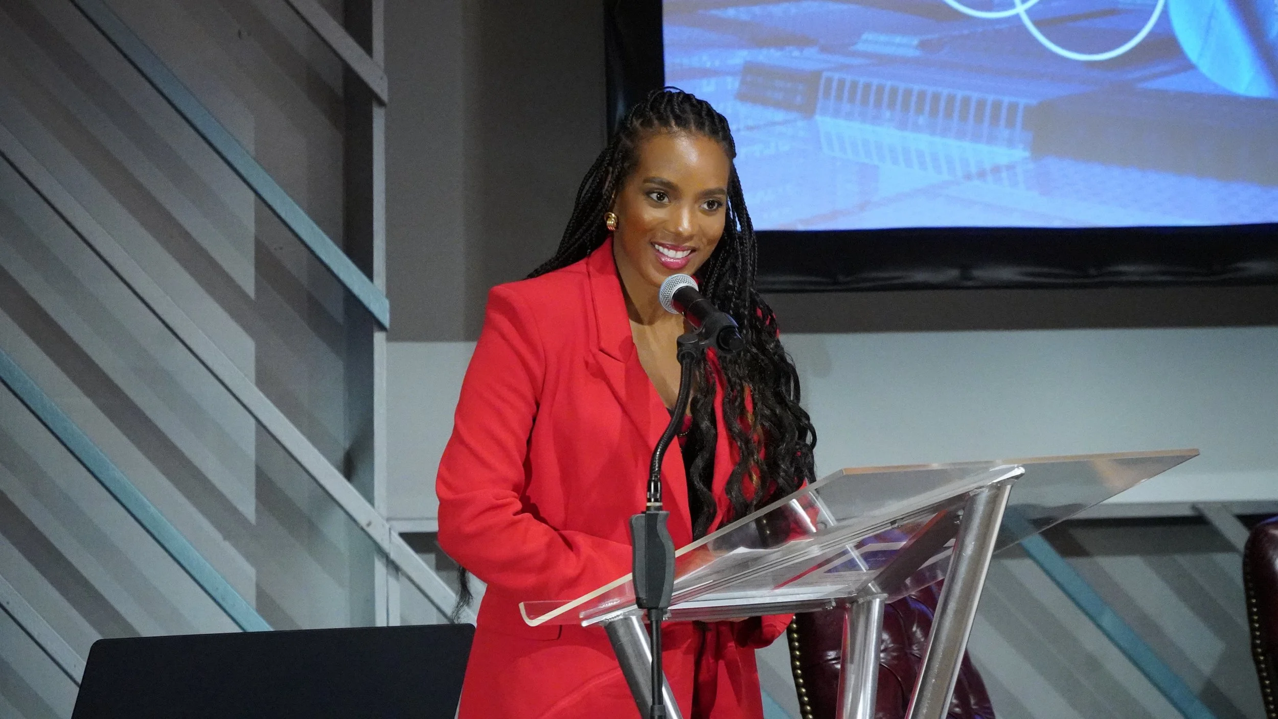 Leading breathwork exercises while emceeing Wonder Woman Tech