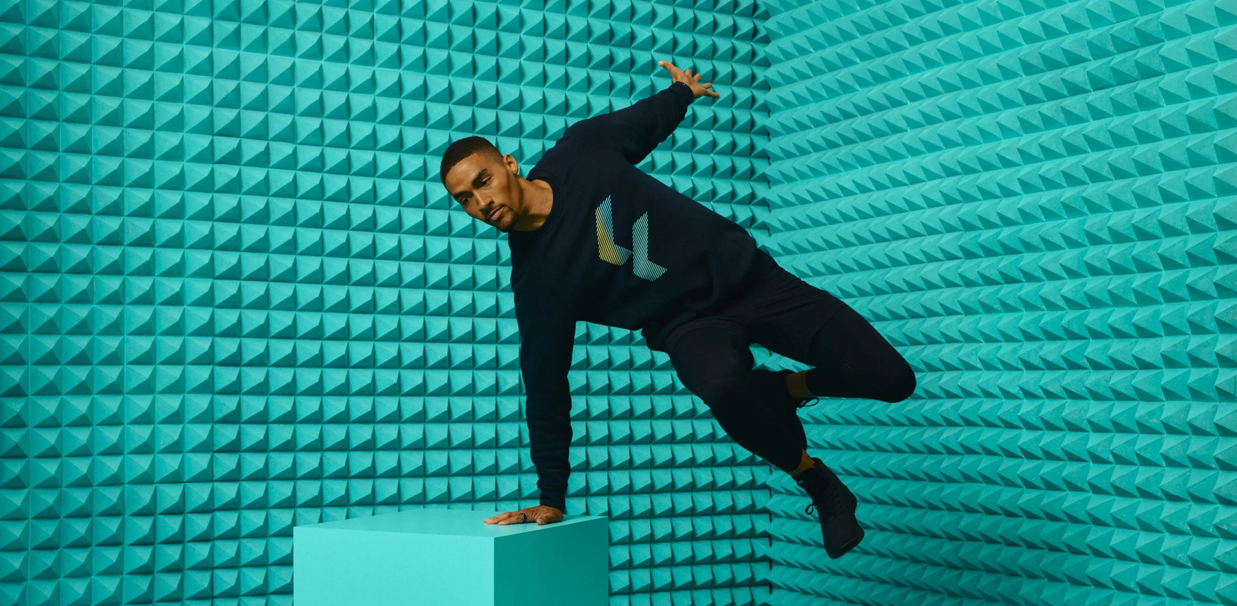 Athletic apparel photography by California commercial photographer Kaare Iverson. Man vaulting a box on an abstract studio set - shot for technology company Future Fit.