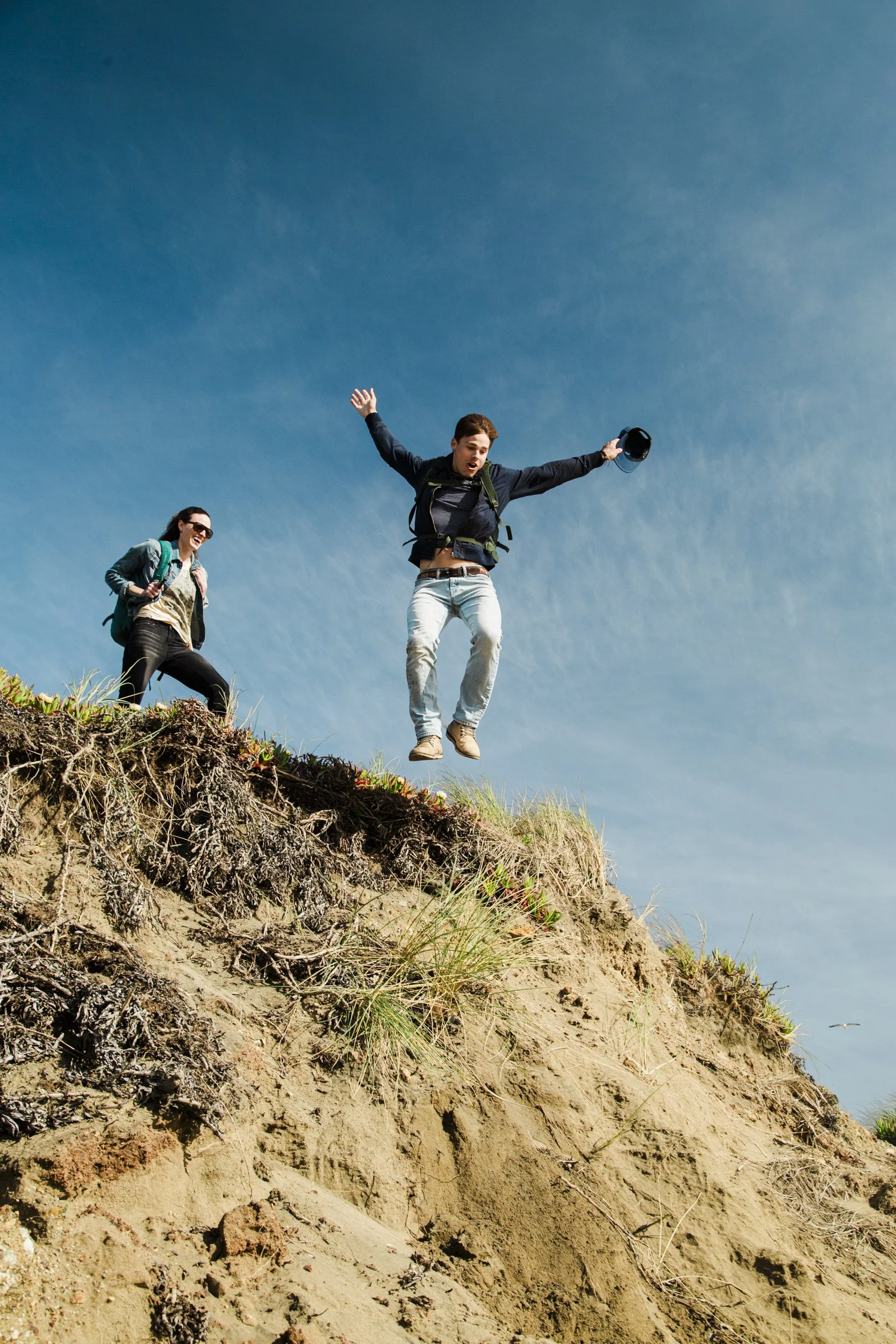 Youth urban product lifestyle photography by Bay Area based photographer Kaare Iverson.  Shot for Osprey Packs, young man jumps off sand dune.