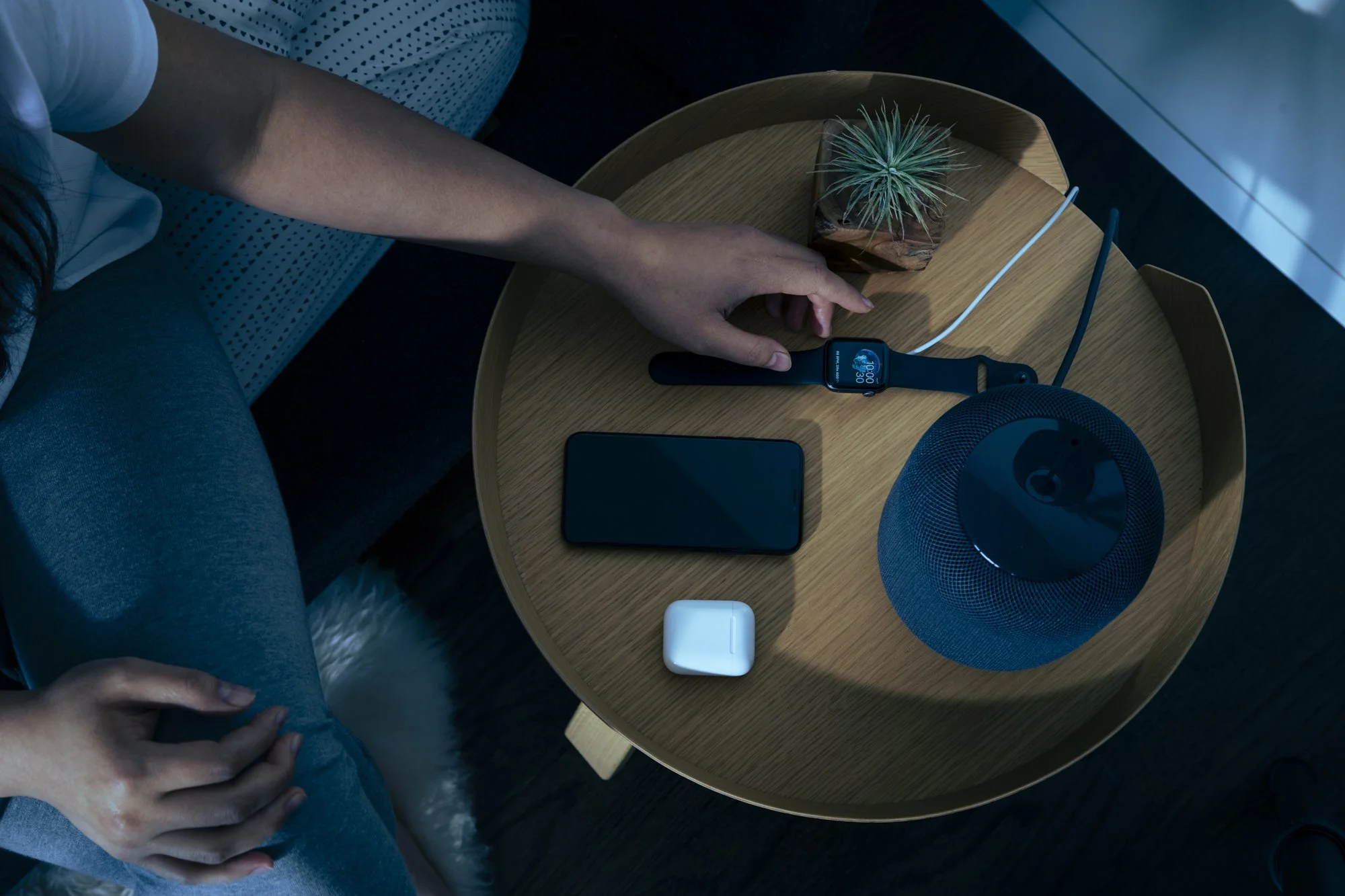 Health technology and app photography for Calm App by California lifestyle photographer Kaare Iverson.  Woman reaches for her smartwatch on a bedside table lit by moonlight.