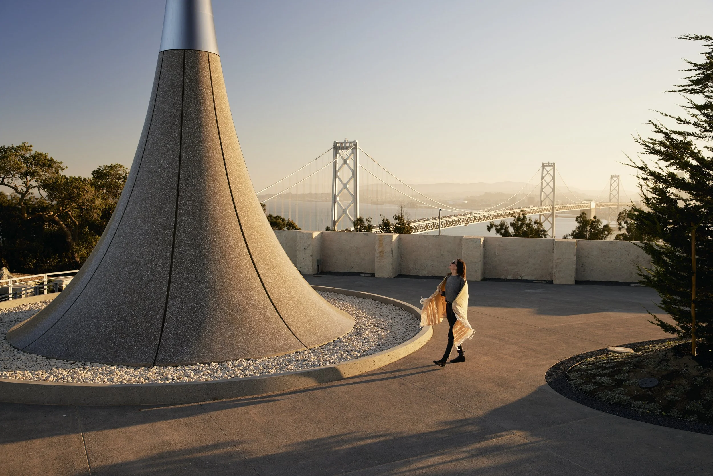 Lifestyle advertising photography for San Francisco's Treasure Island.  Woman admires Point of Infinity at Yerba Buena Island Park in San Francisco.  Shot by California commercial photographer Kaare Iverson.