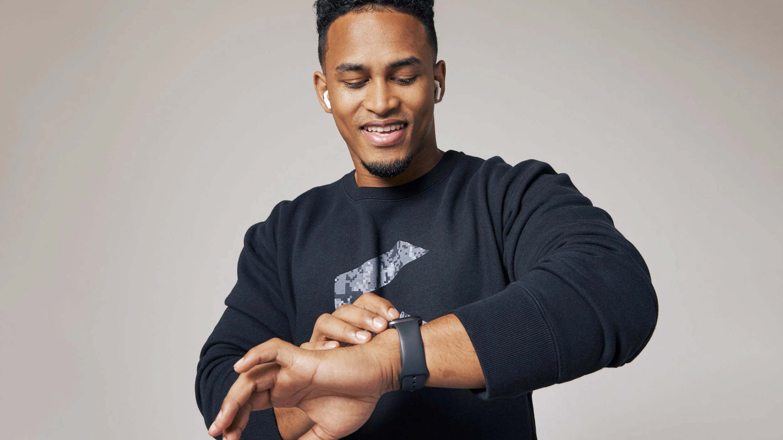 Athletic apparel photography by California commercial photographer Kaare Iverson. Man in a sweater and smartwatch shot for technology company Future Fit.

