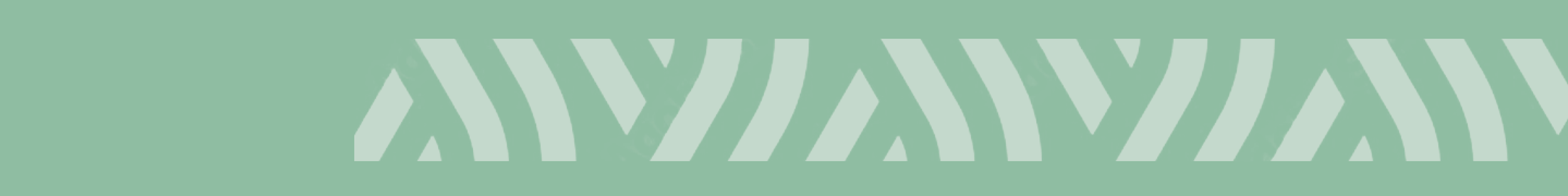 A close-up of a patterned fabric or wallpaper with light green background and white zigzag or chevron design.