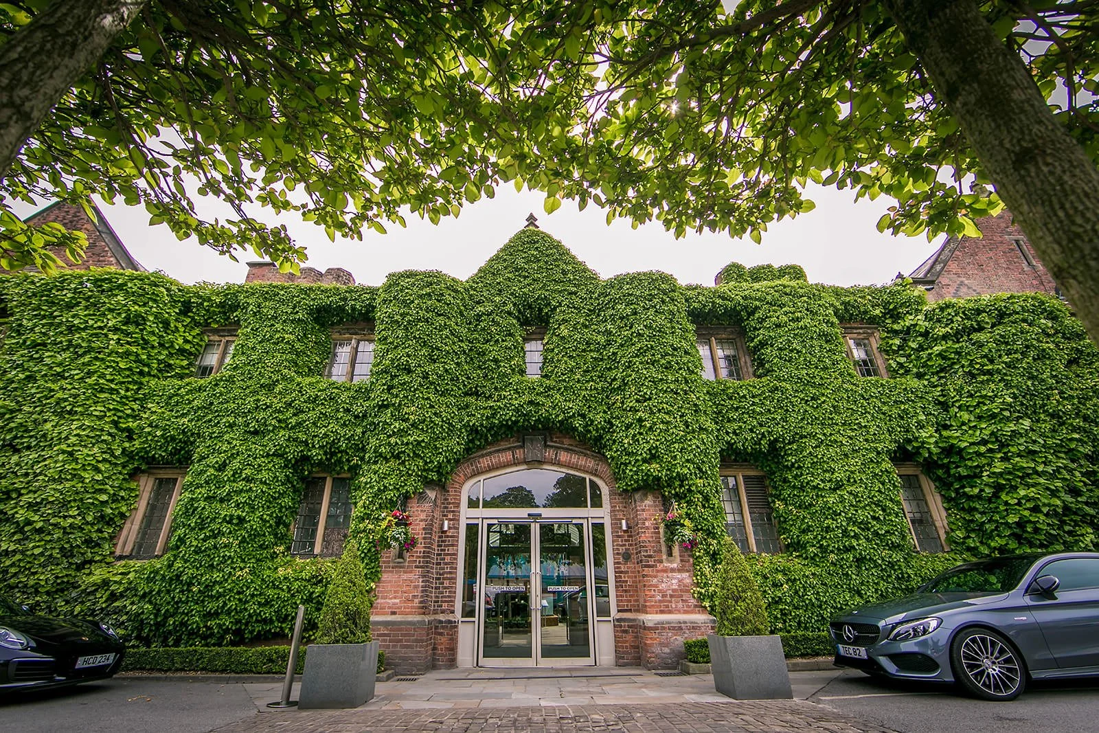 Fairmont Cheshire - The Mere exterior covered in summer ivy, Knutsford wedding venue

