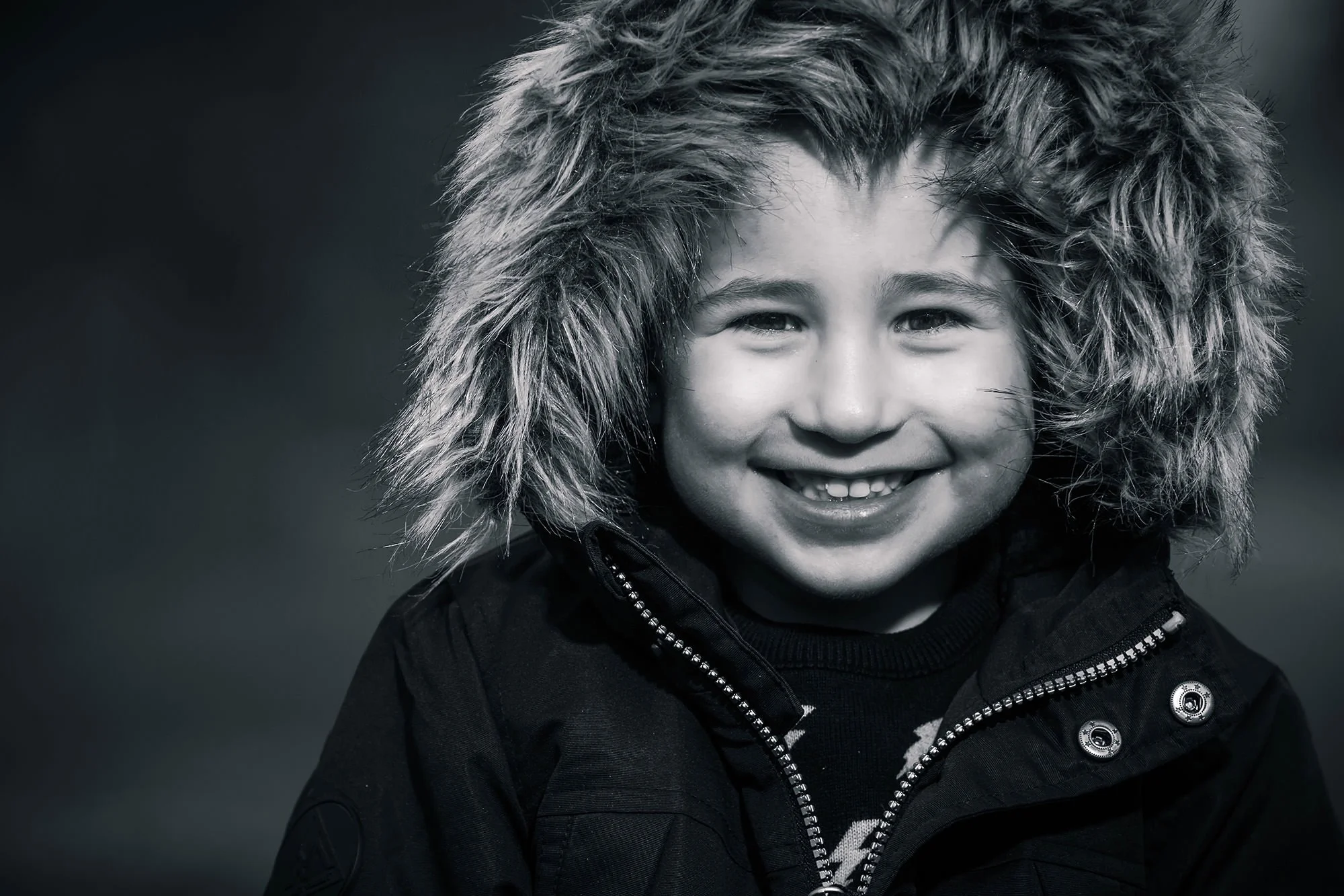 natural light black and white portrait of boy in park