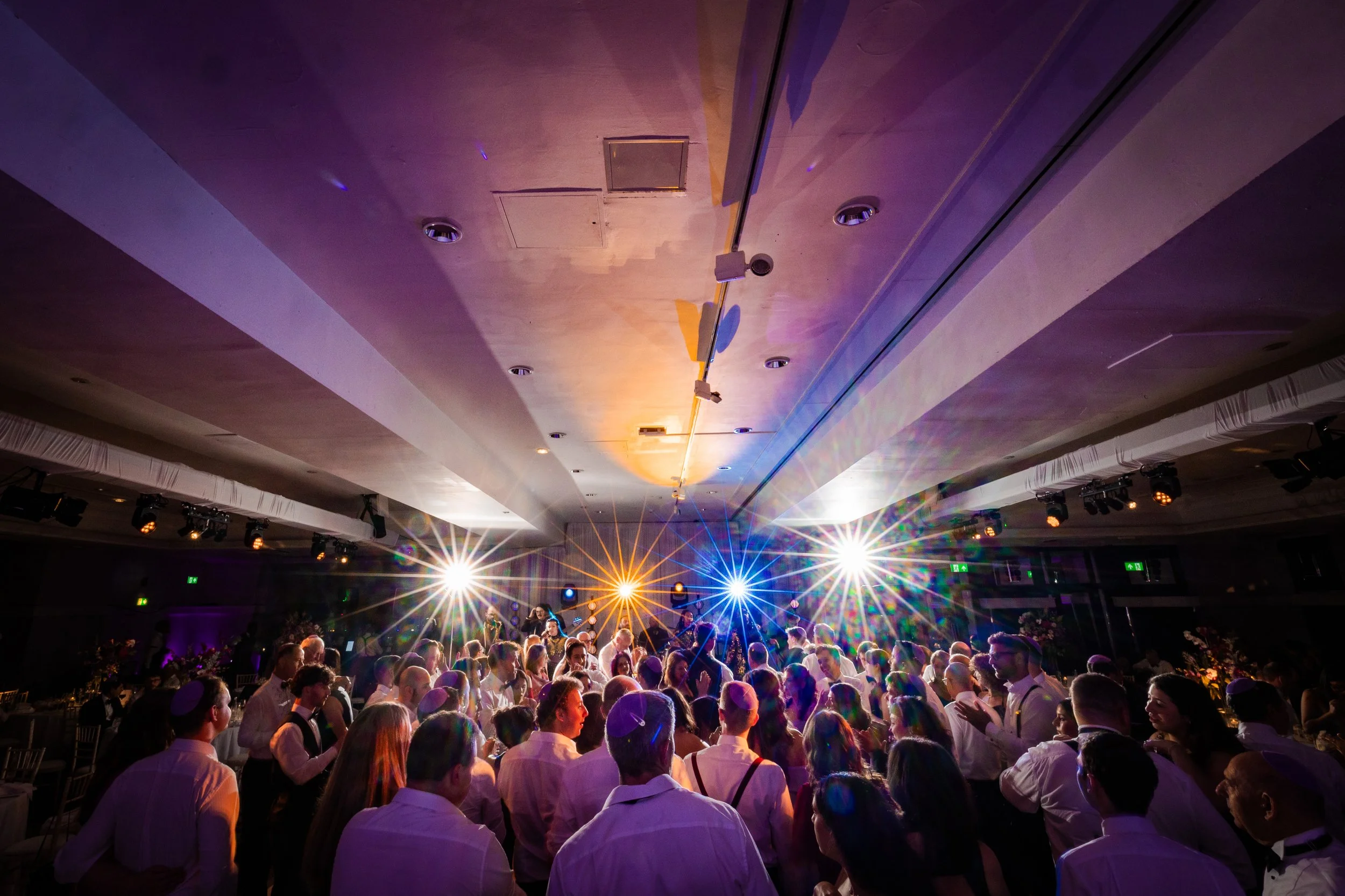 atmospheric wide angle crowd shot of wedding reception dance floor at midland hotel