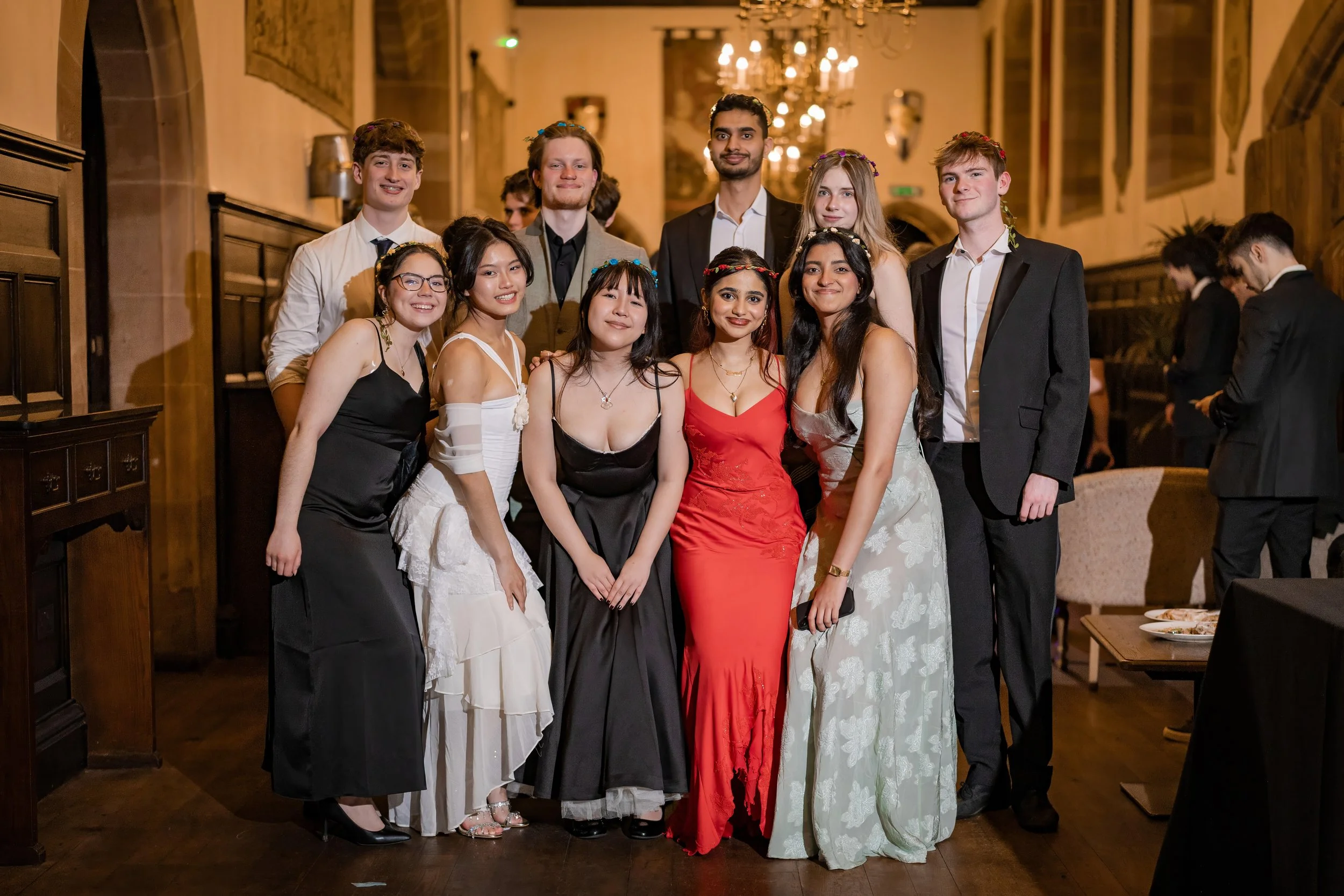 Friends celebrating together during the Manchester University Law Society Summer Ball at Peckforton Castle