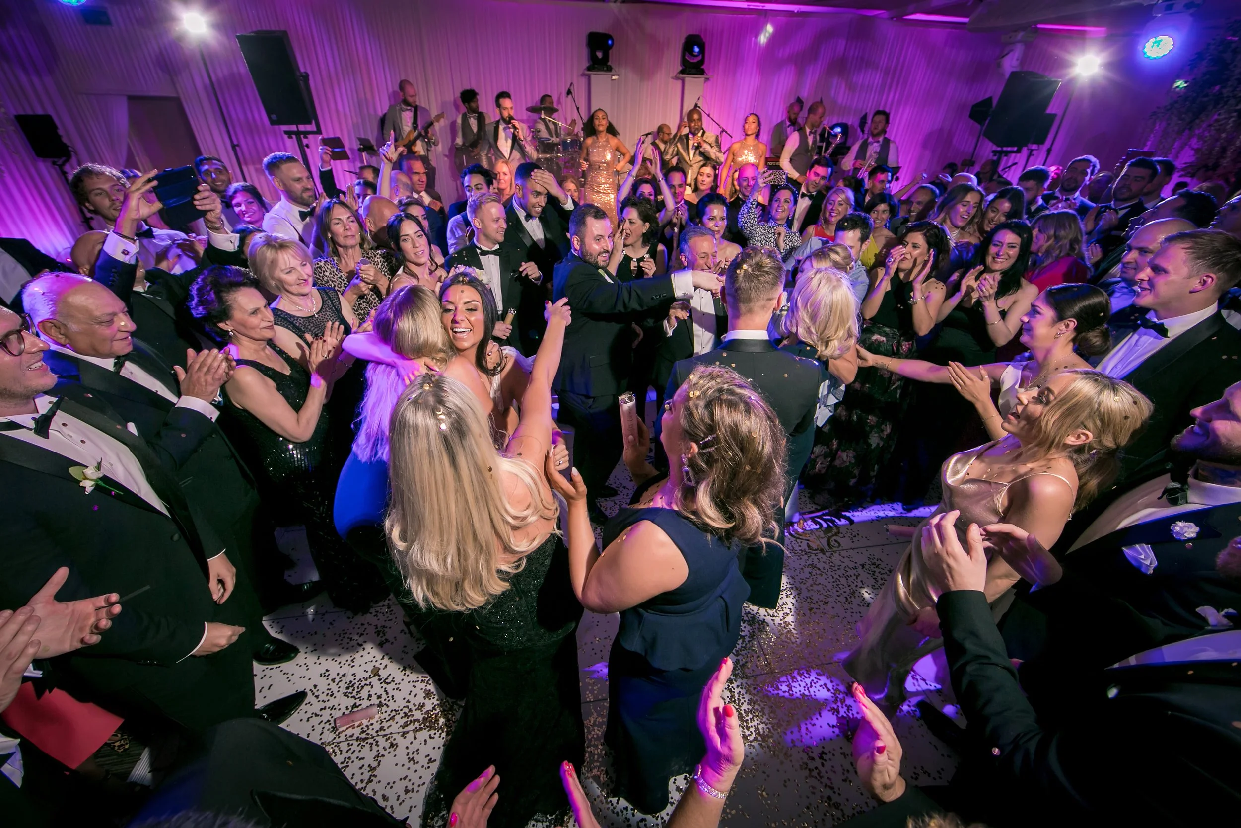 Full dance floor at Fairmont Cheshire - The Mere wedding, pink lighting

