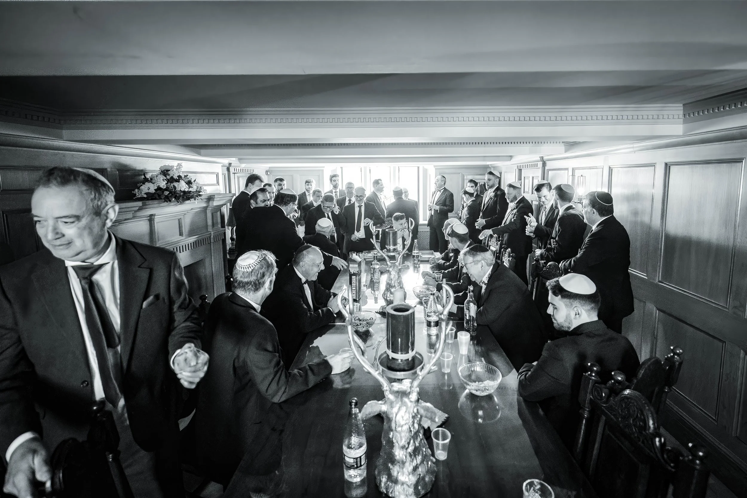 Merrydale Manor wedding guests in formal attire wooden panelled room – fine art wedding photographer North West