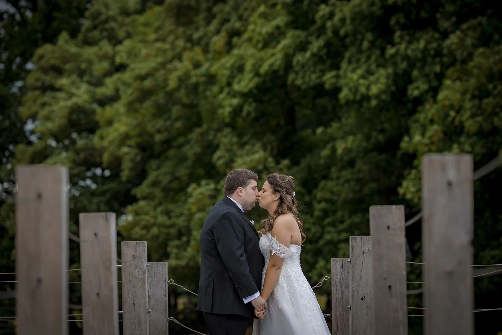 bride and groom romantic portrait on the jetty over the pond at merrydale manor wedding venue