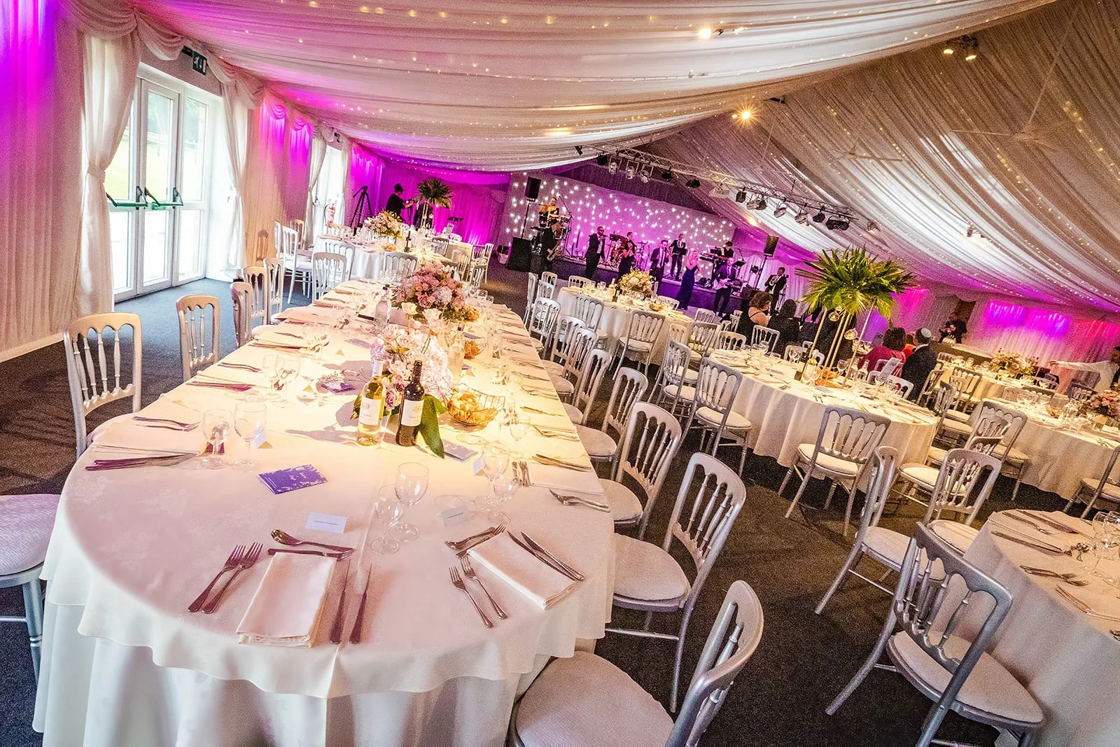 heaton house farm wedding reception dinner set up in steel barns