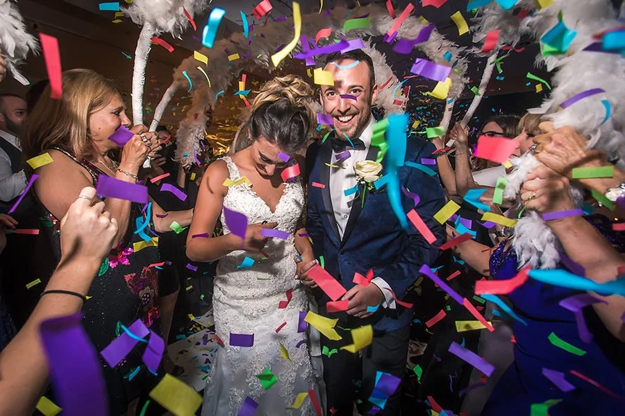 bride and groom make entrance to reception dancing with confetti at midland hotel