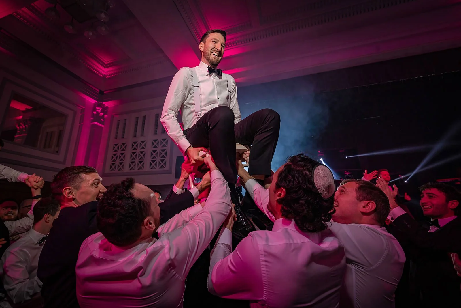 groom lifted on chair during reception party dancing at kimpton clocktower manchester