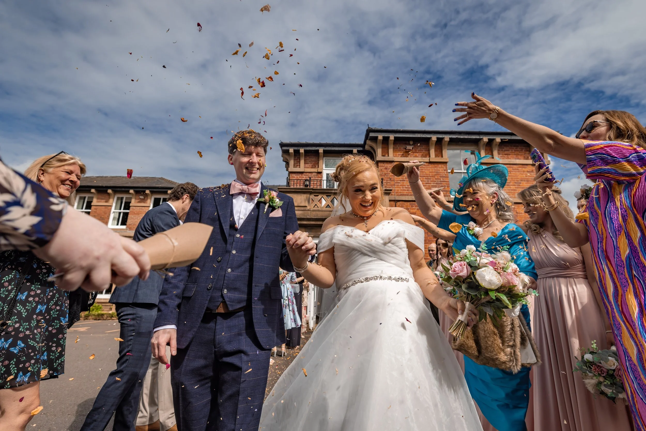 Bride and groom showered with confetti outdoors in Manchester