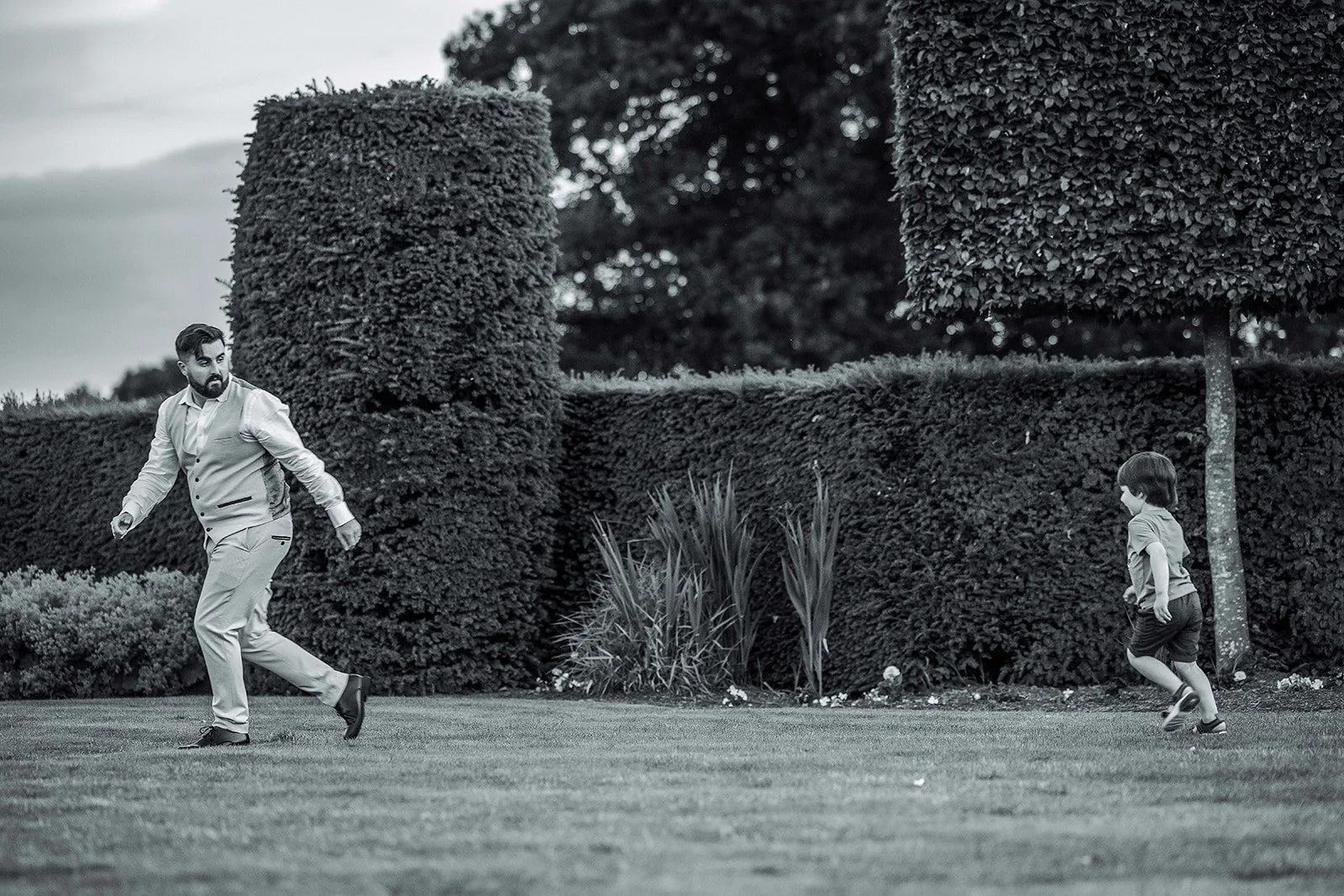 Merrydale Manor wedding groom playing with young child outdoors – fine art wedding photographer North West
