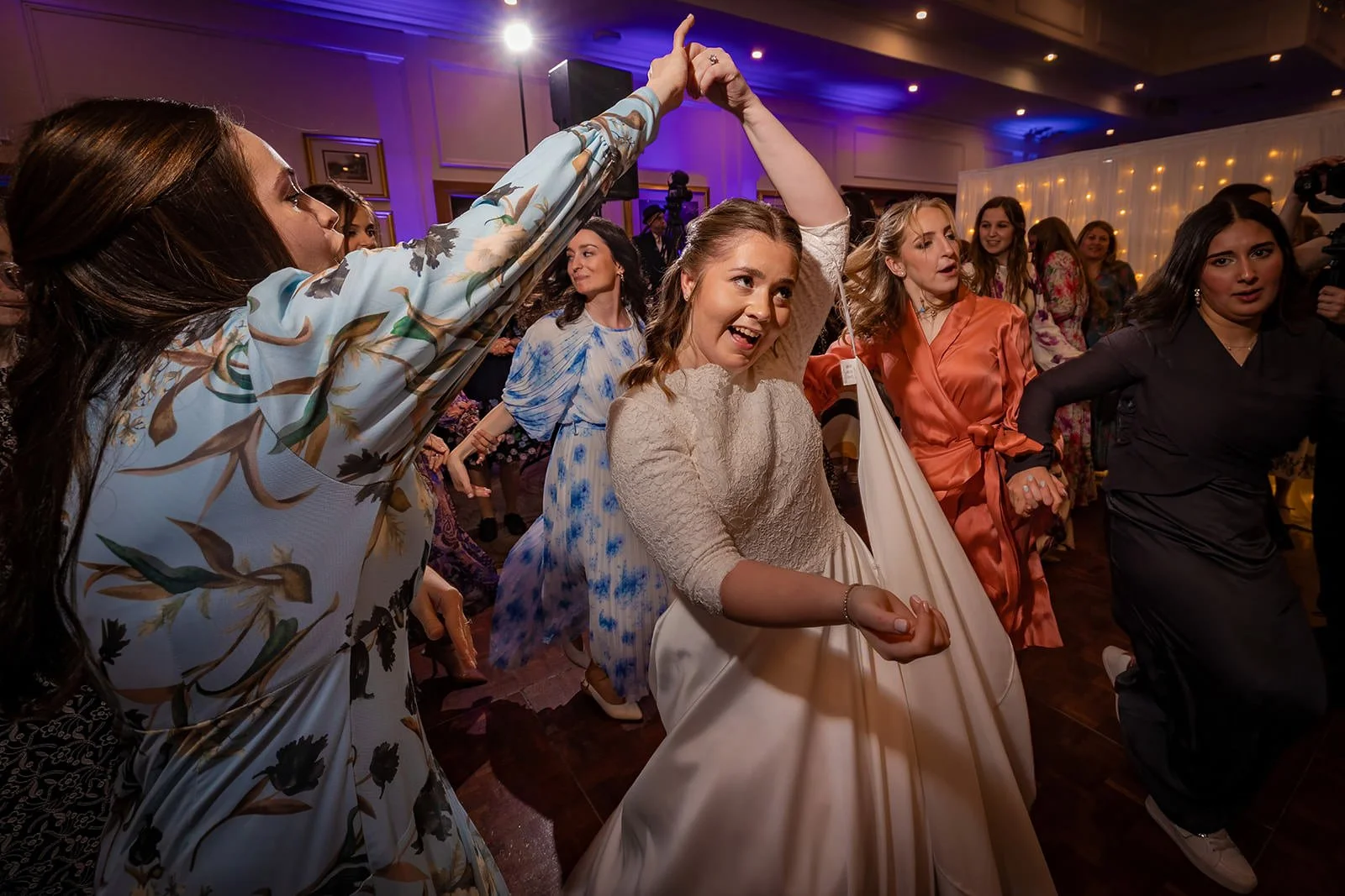 bride dancing during wedding party reception at last drop village in bolton