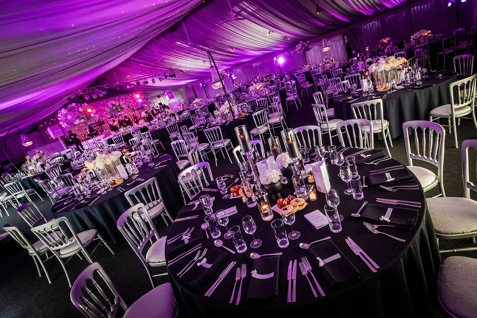heaton house farm wedding reception dinner set up in steel barns