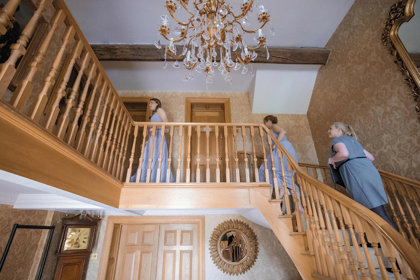 Merrydale Manor wedding flower girls in blue dresses on staircase – documentary wedding photography Manchester