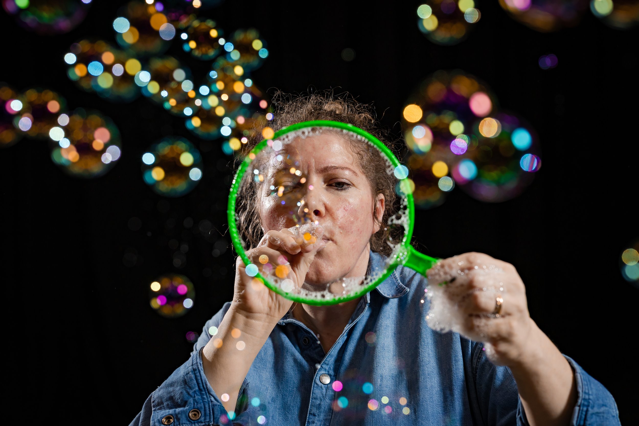 corporate-workshop-photographer-manchester-participant-blowing-bubble-wand-close-034.jpg