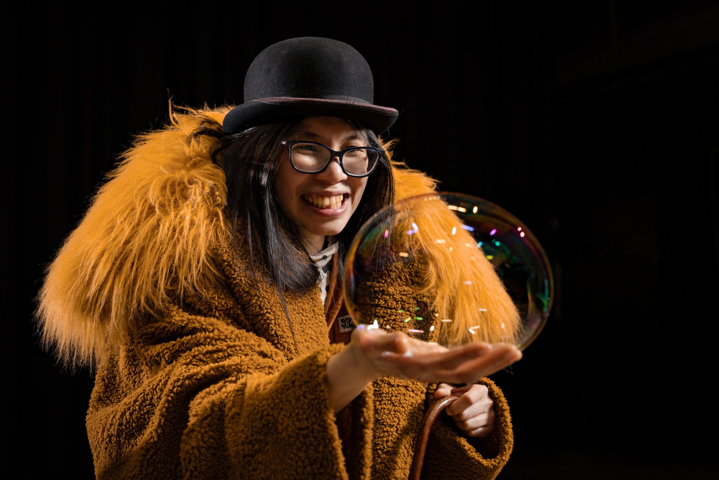 corporate-workshop-photographer-manchester-participant-bowler-hat-holding-bubble-019.jpg