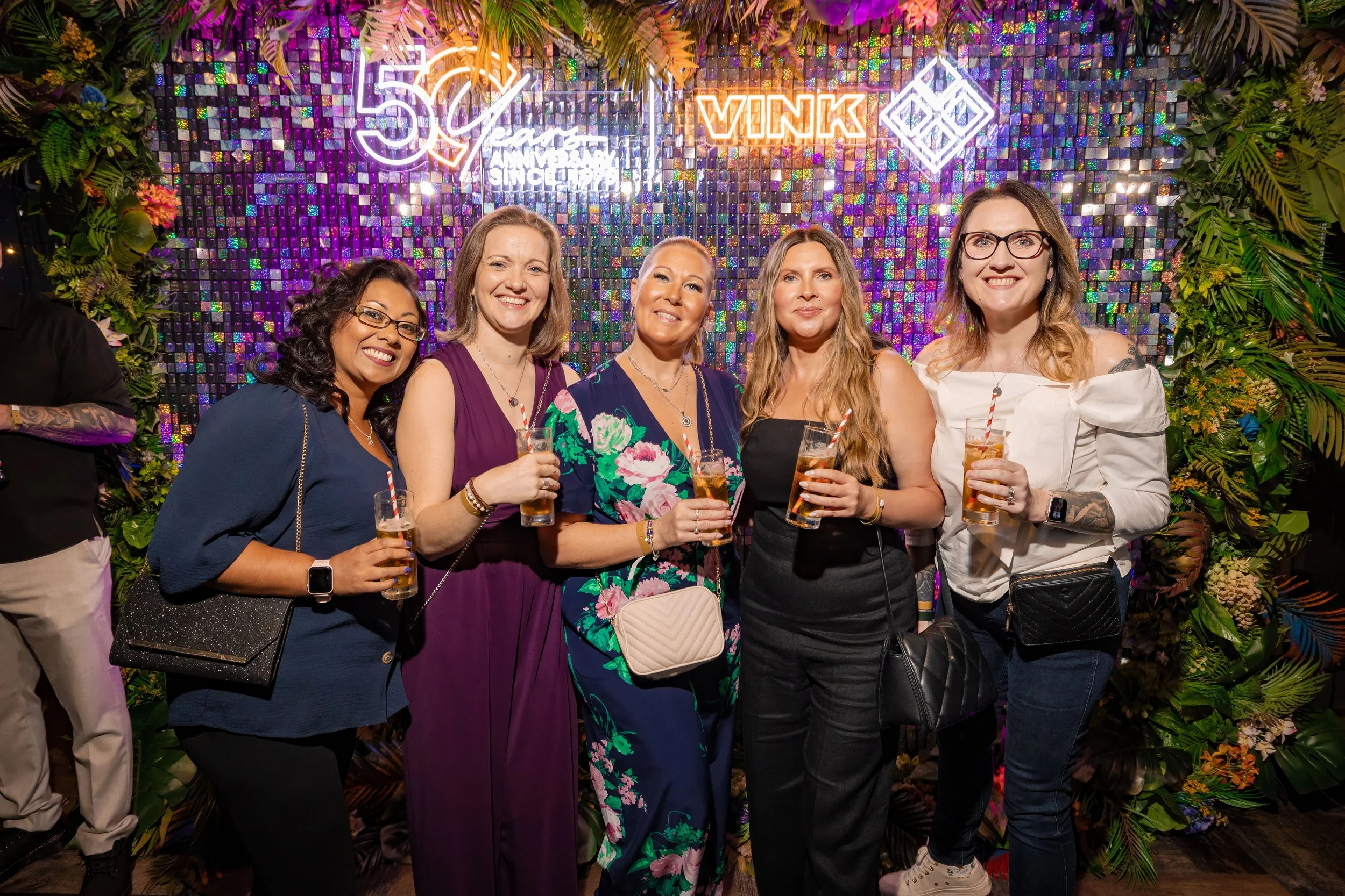 company-celebration-photography-women-guests-drinks-vink-backdrop.jpg