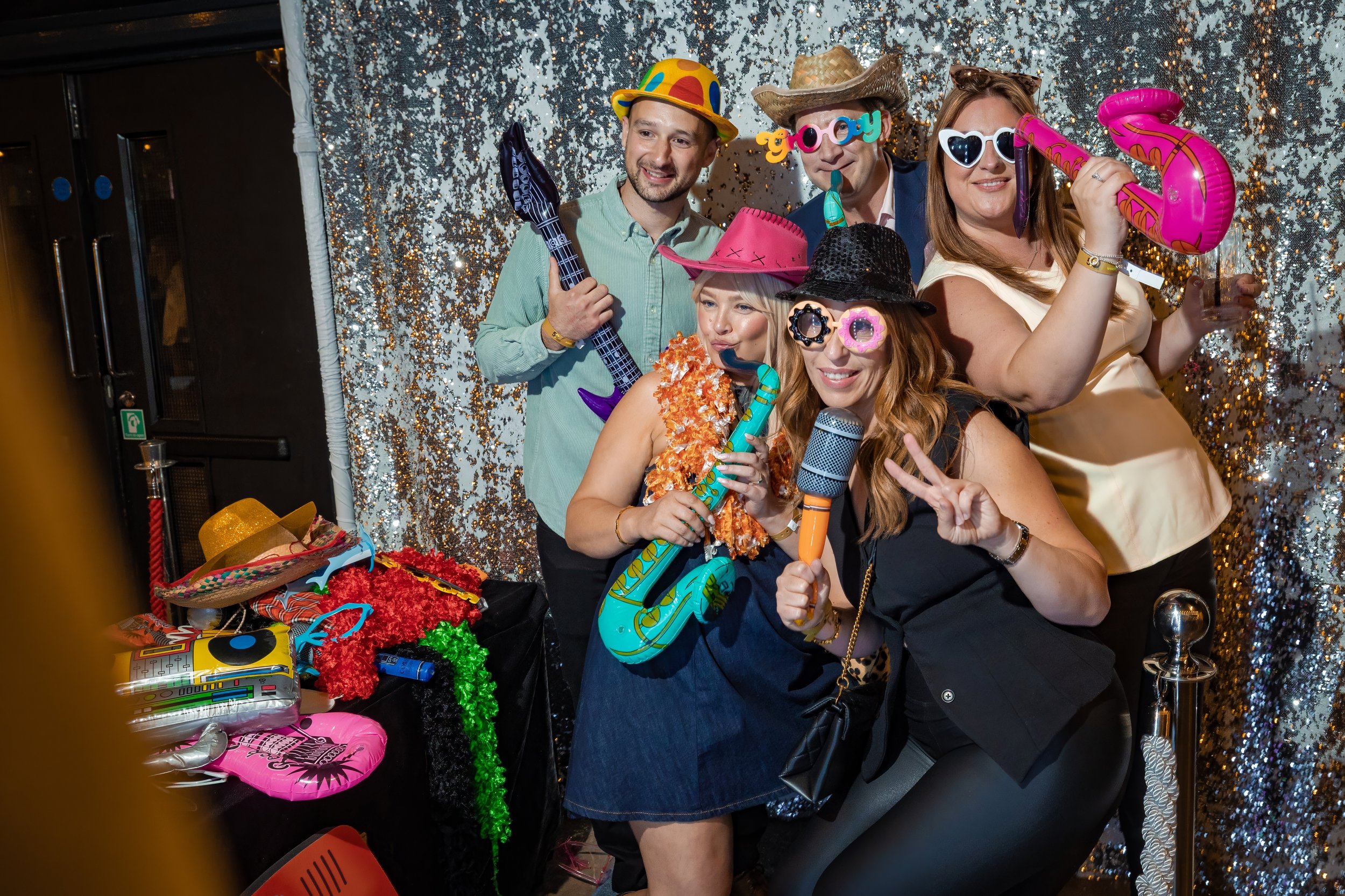 corporate-party-photography-photo-booth-props-guests-laughing.jpg