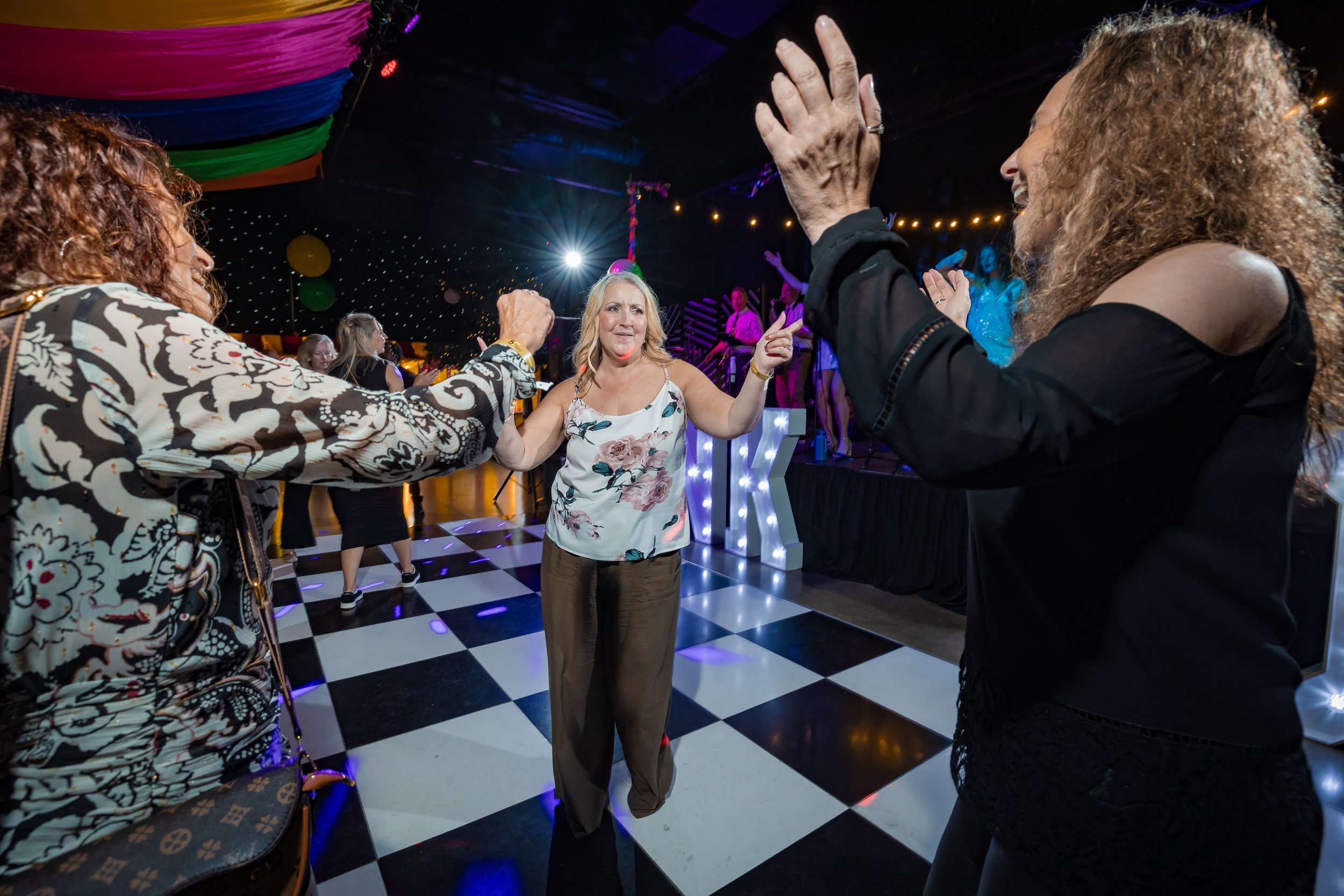 corporate-party-photography-guests-circle-dancing-dancefloor-anniversary.jpg
