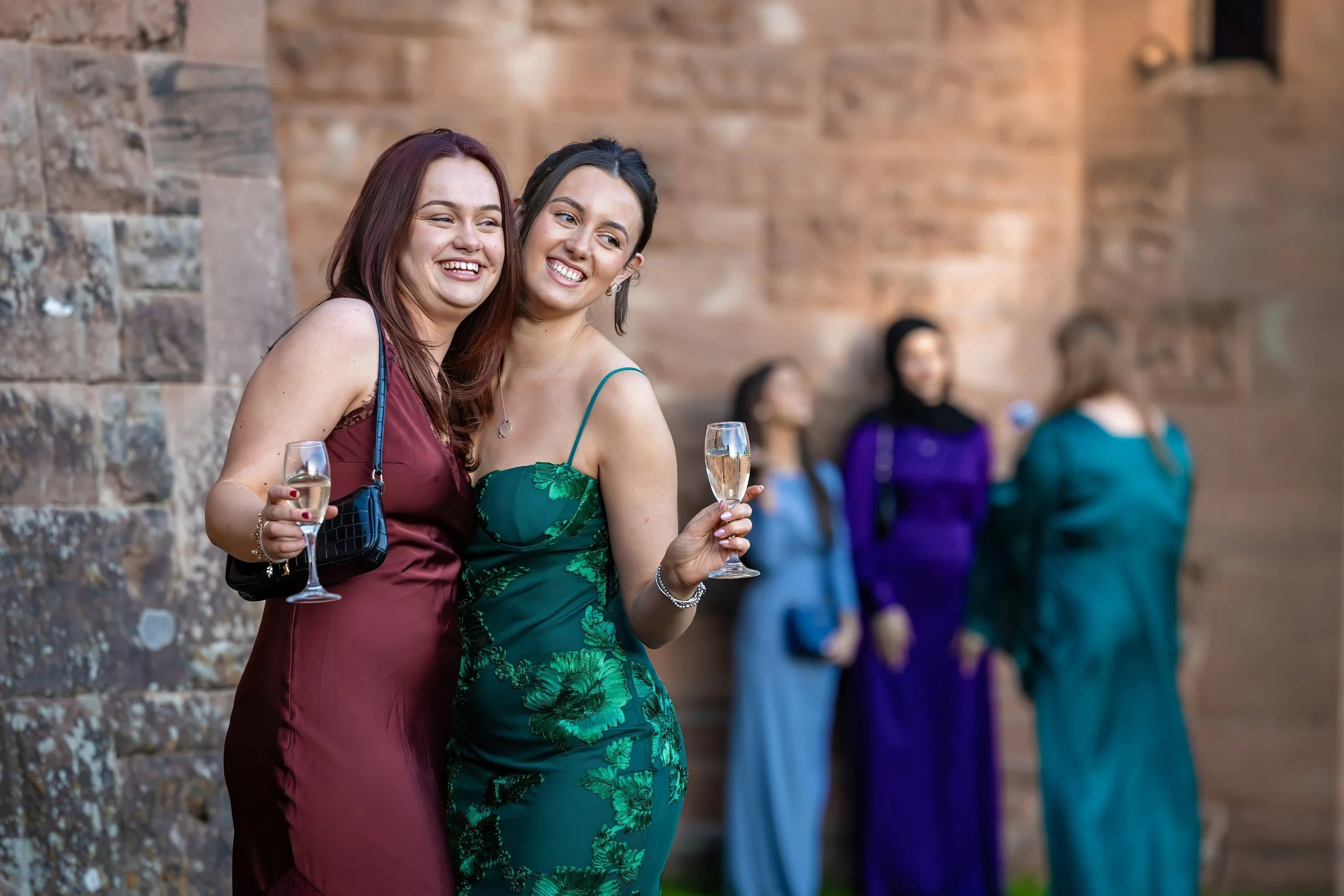 drinks-reception-guests-champagne-smiling-castle-wall.jpg