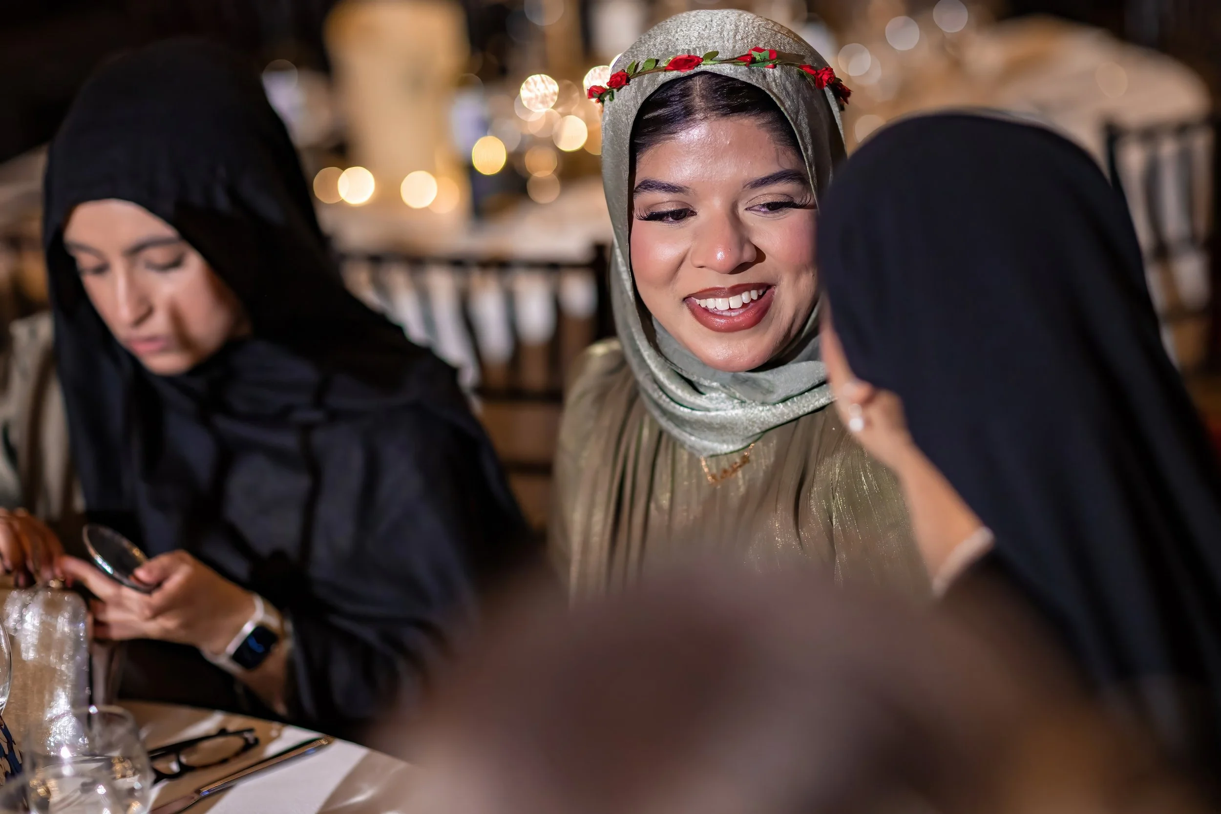 gala-dinner-guest-smiling-candlelit-table-portrait.jpg