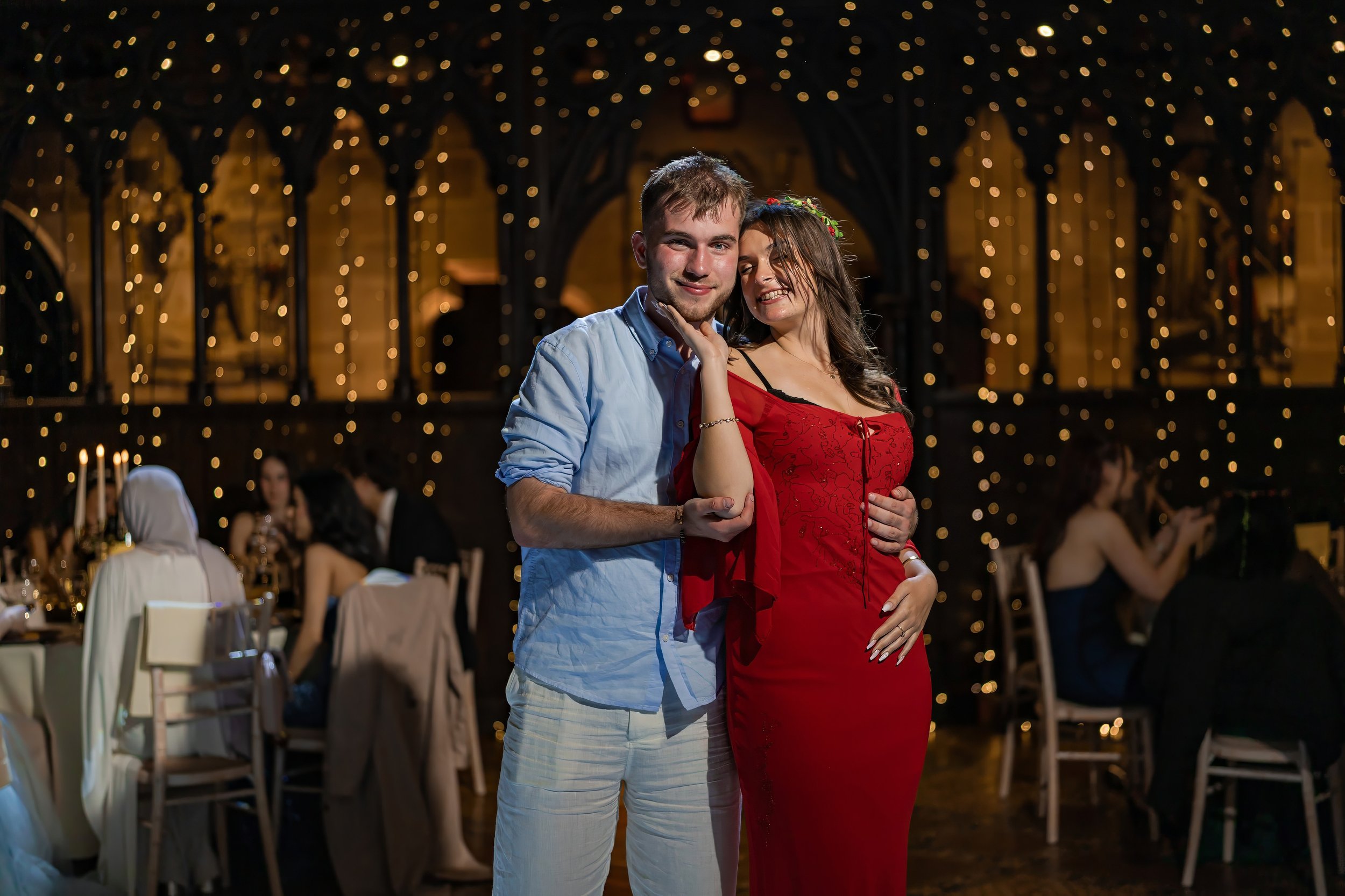 couple-posing-summer-ball-fairy-lights-castle-portrait.jpg