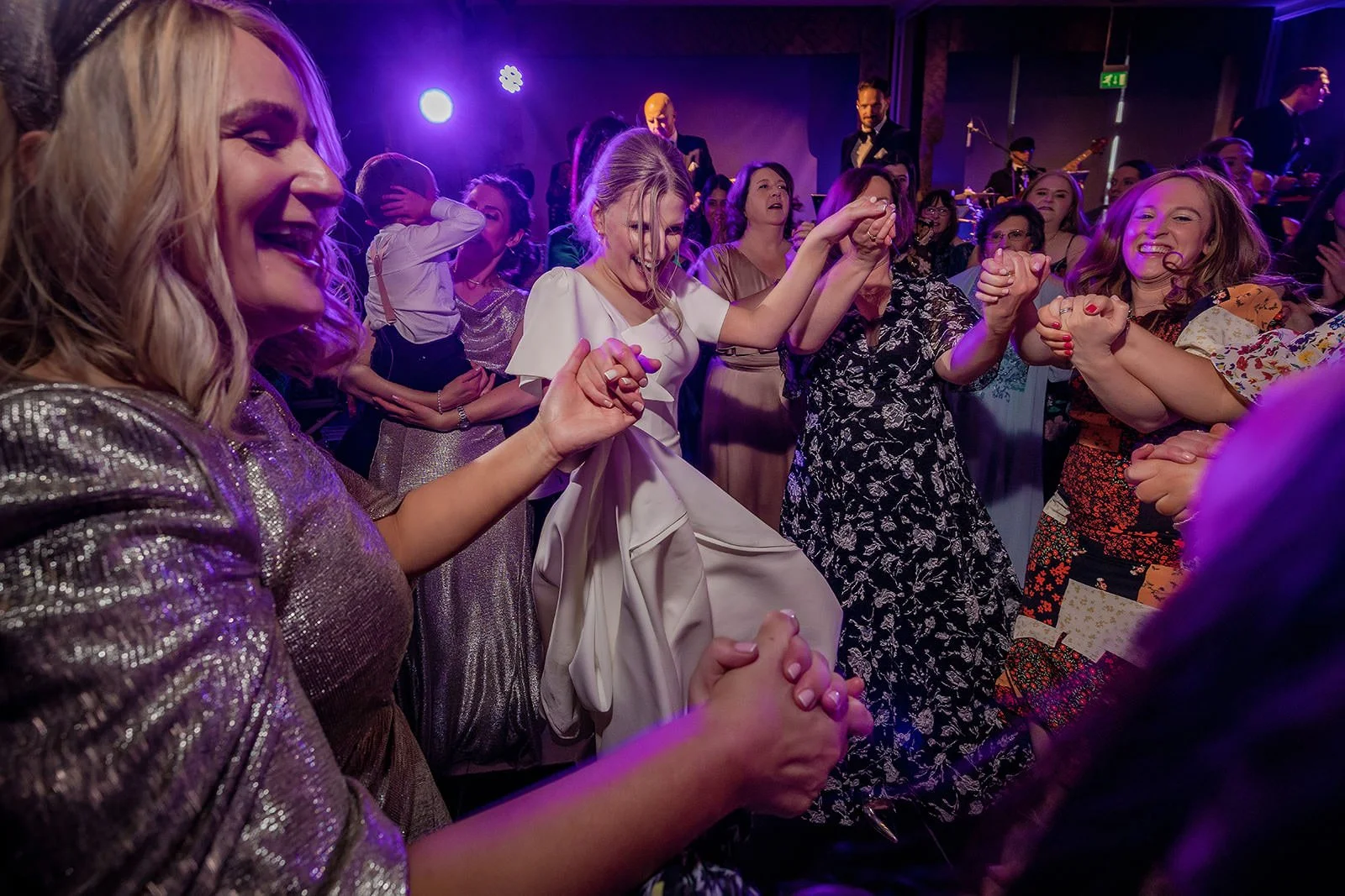 bride and family dancing during reception at mere golf resort in cheshire