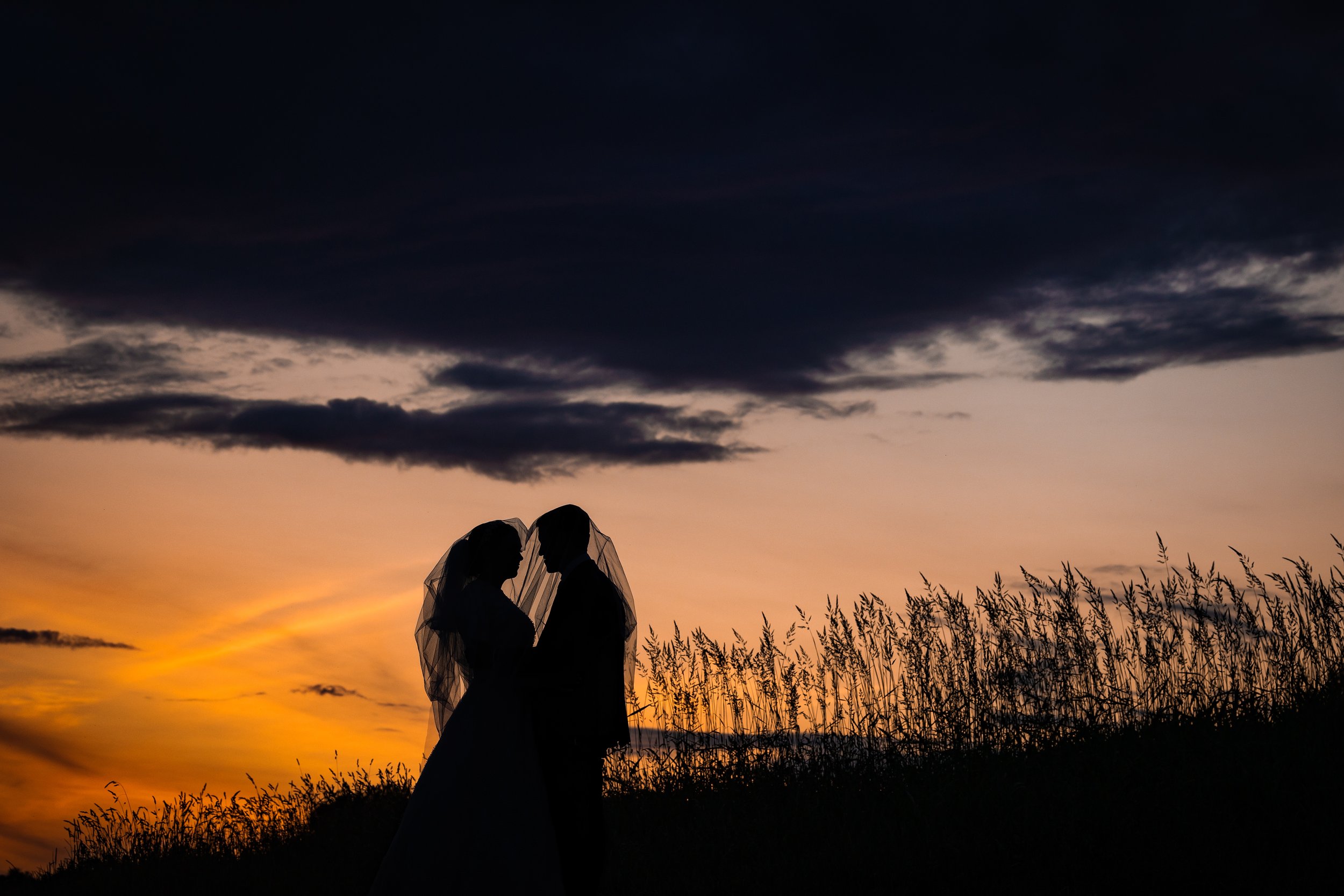 atmospheric silhouette of kallah bride and chosson groom portrait with sunset