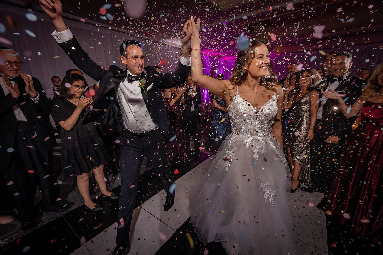 bride and groom entrance to dance floor with confetti at mere golf resort in cheshire