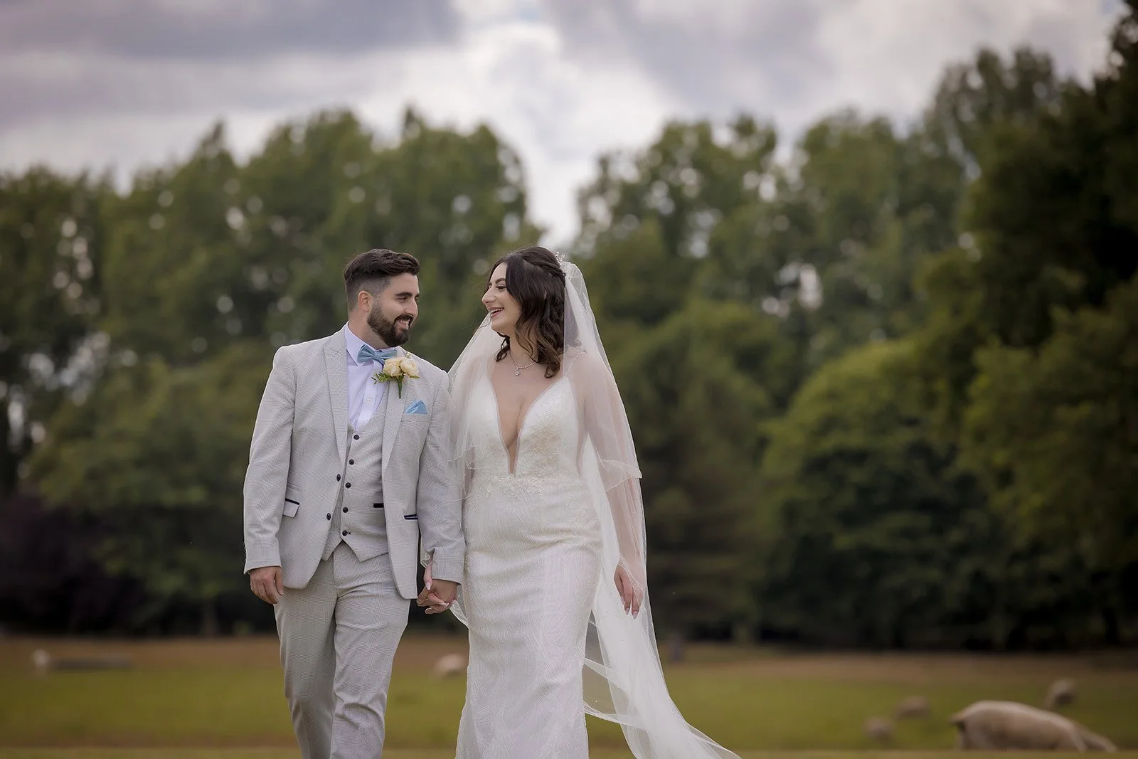 Merrydale Manor wedding couple walking hand in hand smiling outdoors – fine art wedding photographer North West