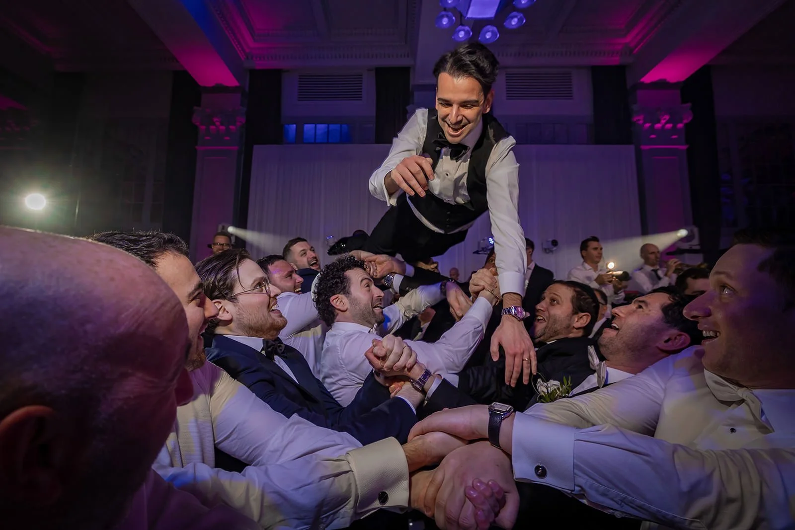groom thrown in air during reception party dancing at kimpton clocktower manchester