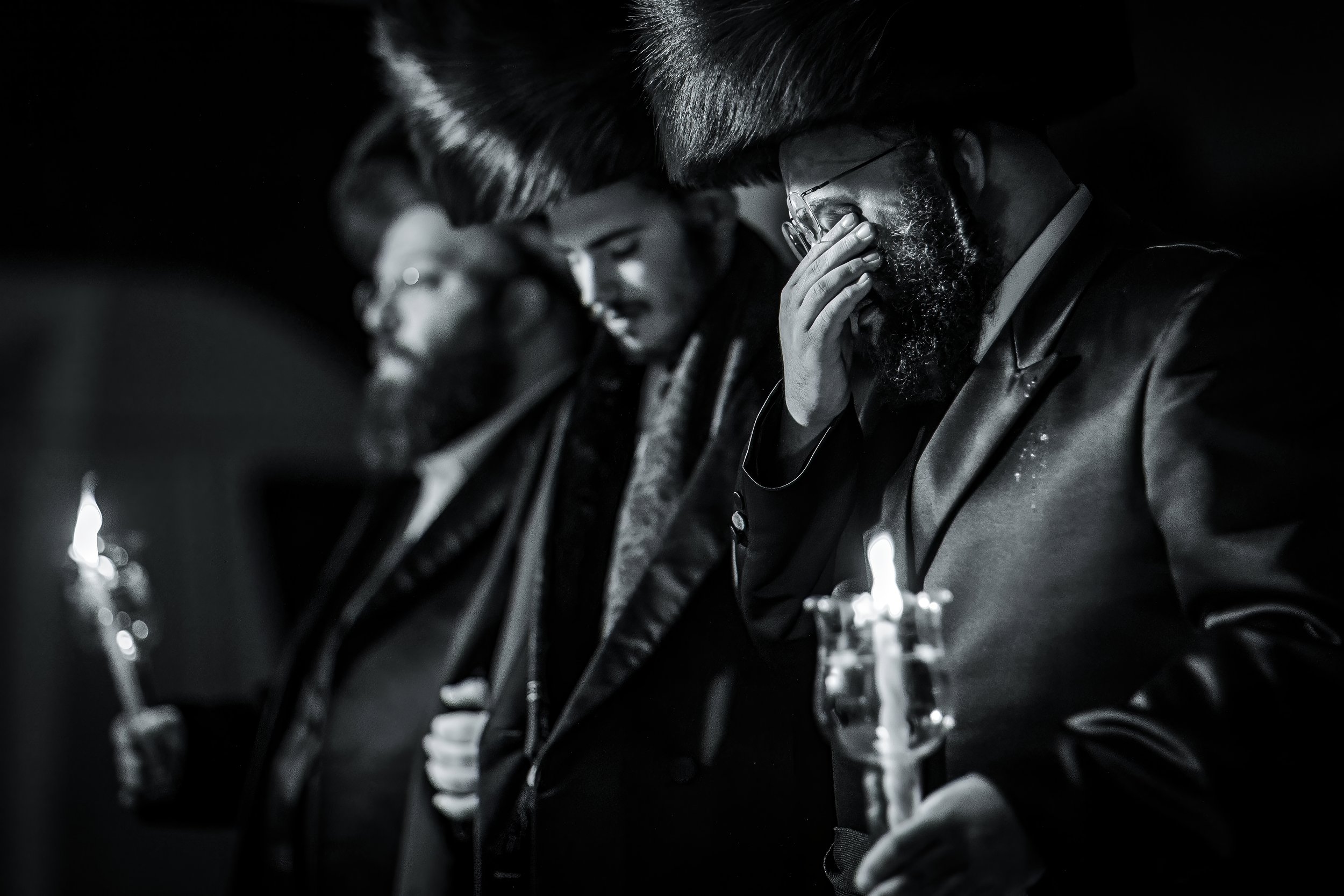 chosson groom under chuppah with emotional father at charedi jewish wedding ceremony