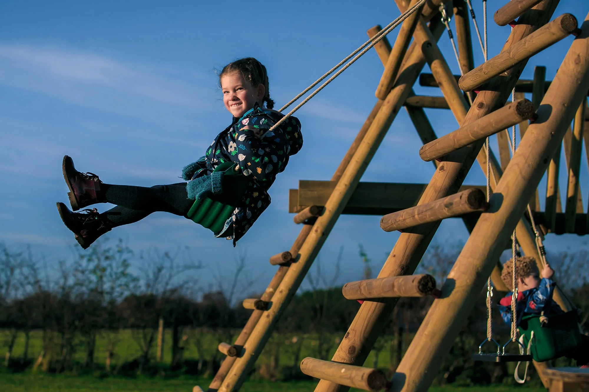 natural light golden hour portrait of girl on swing in garden