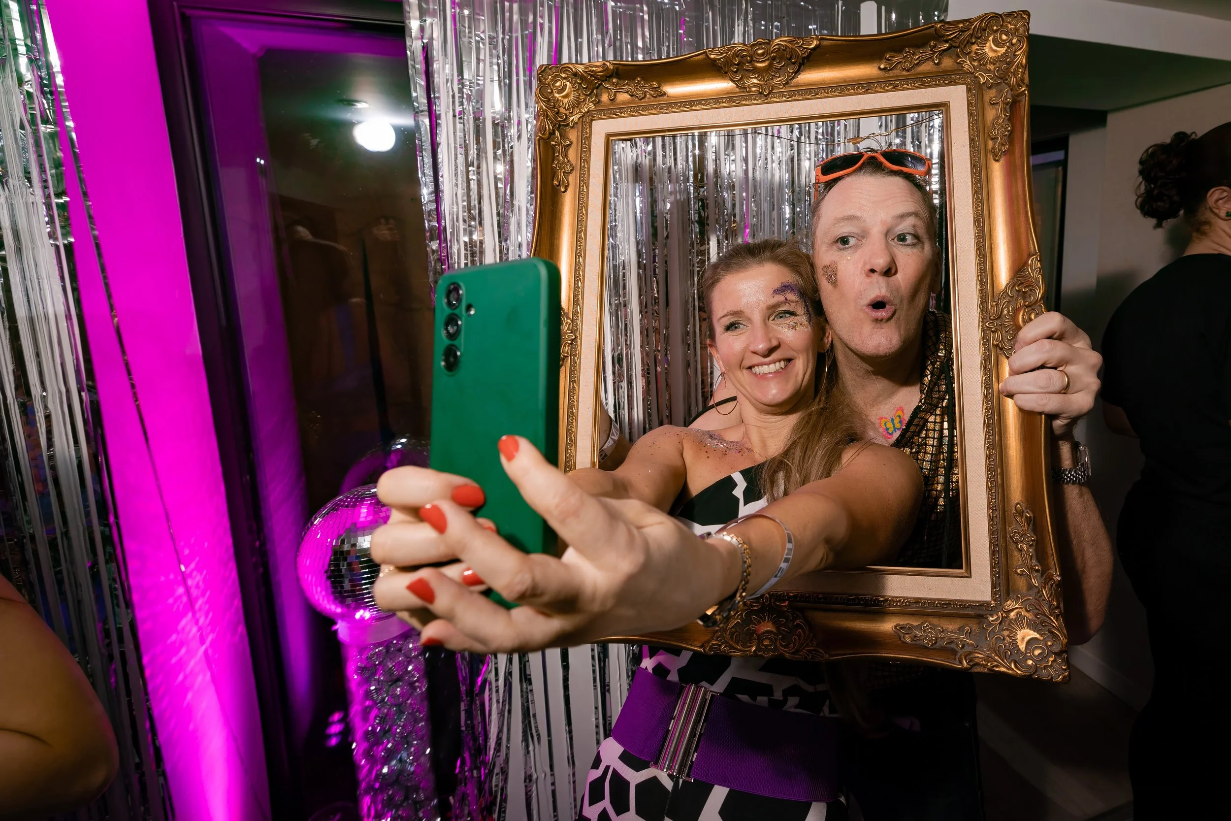 guests pose for selfie through a frame at private party in Leeds