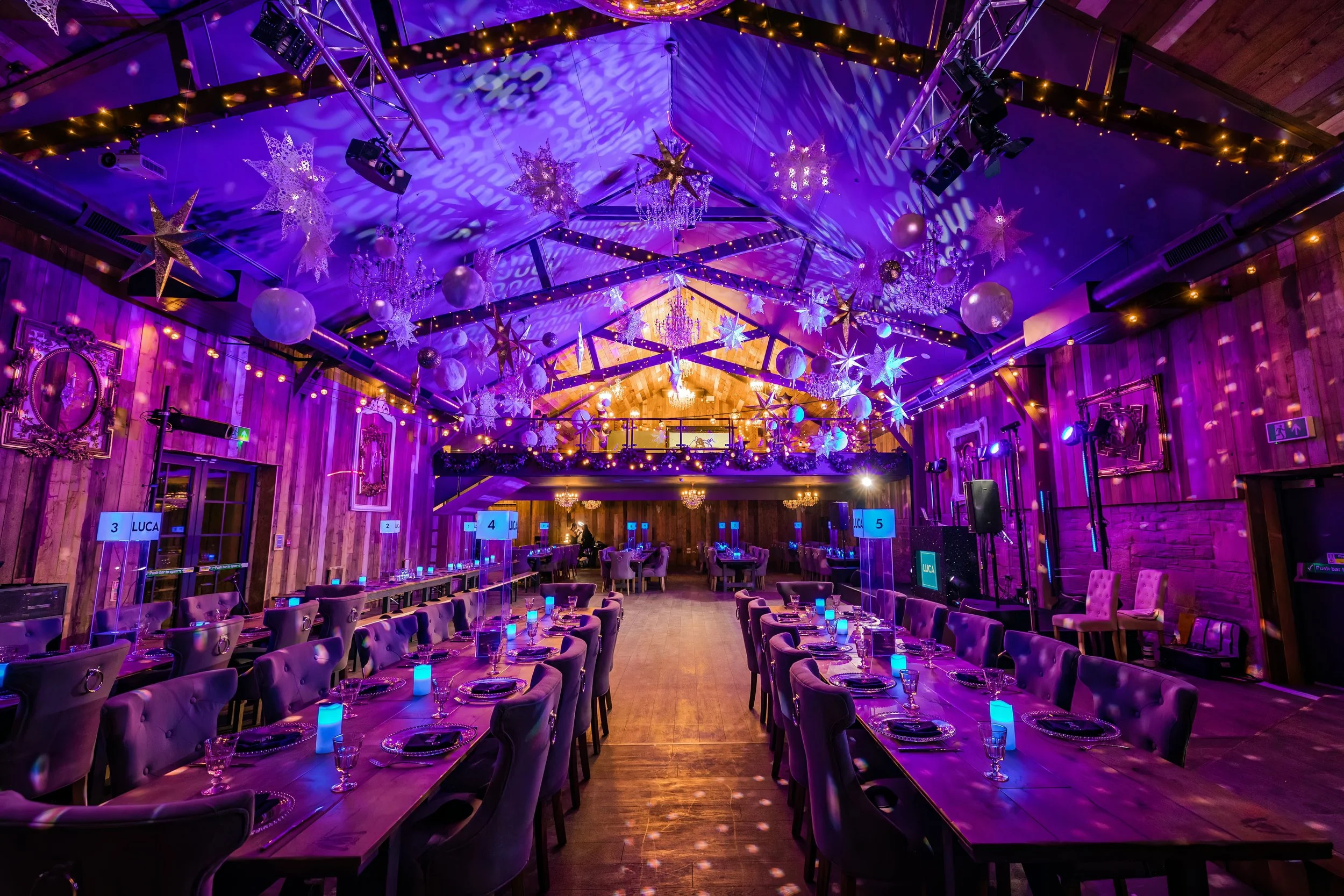 barmitzvah party room set up with decor and lights and tables and decorations