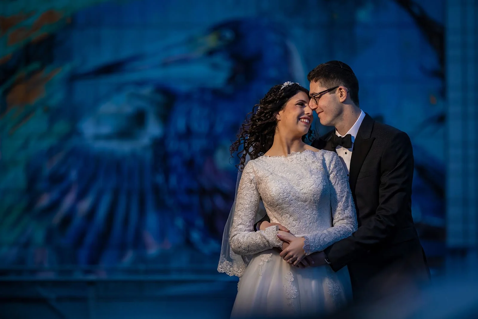 bride and groom newlywed couple portrait with mural outside mercure manchester piccadilly