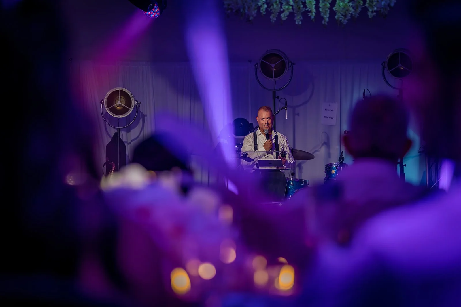 Atmospheric evening lighting during wedding reception in Nunsmere Hall marquee
