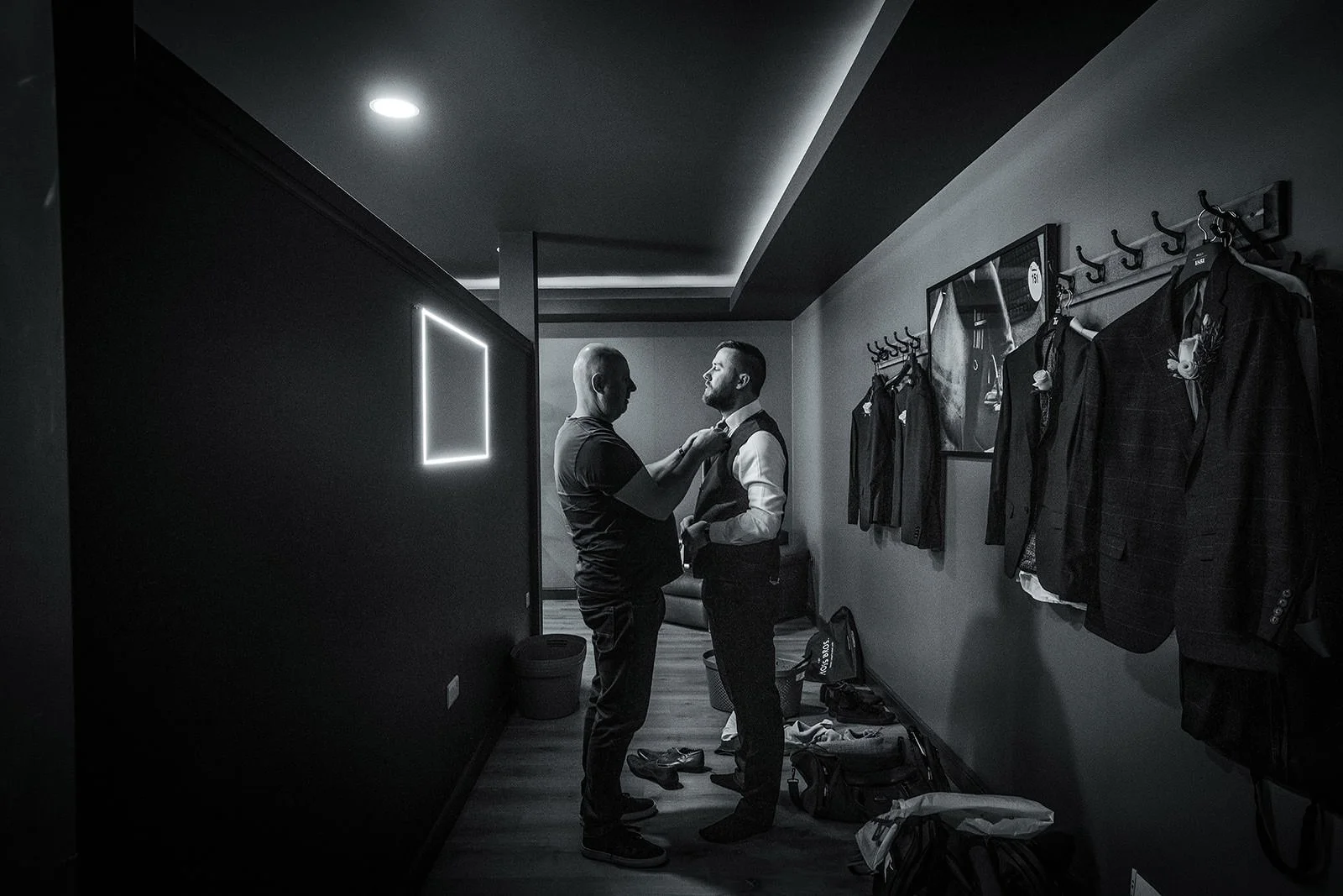 groom gets help with tie in the den at colshaw hall during prep